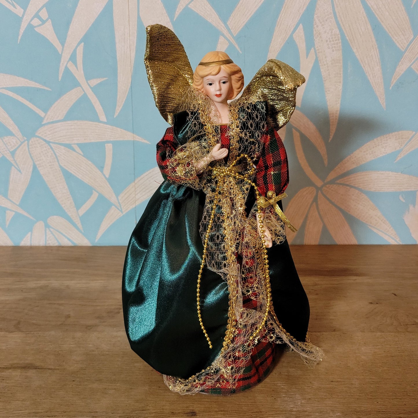Vintage angel tree topper in plaid-sleeved green dress with porcelain face and hands