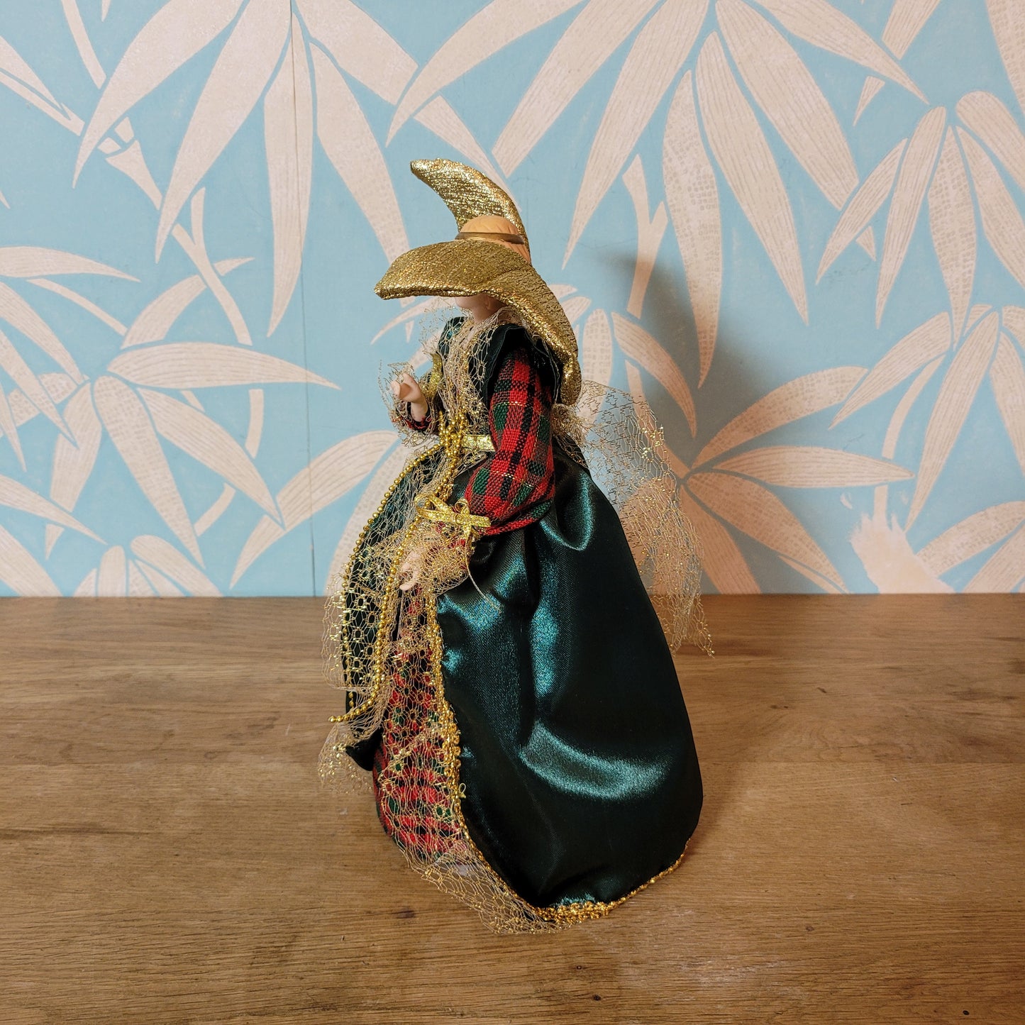 Vintage angel tree topper in plaid-sleeved green dress with porcelain face and hands