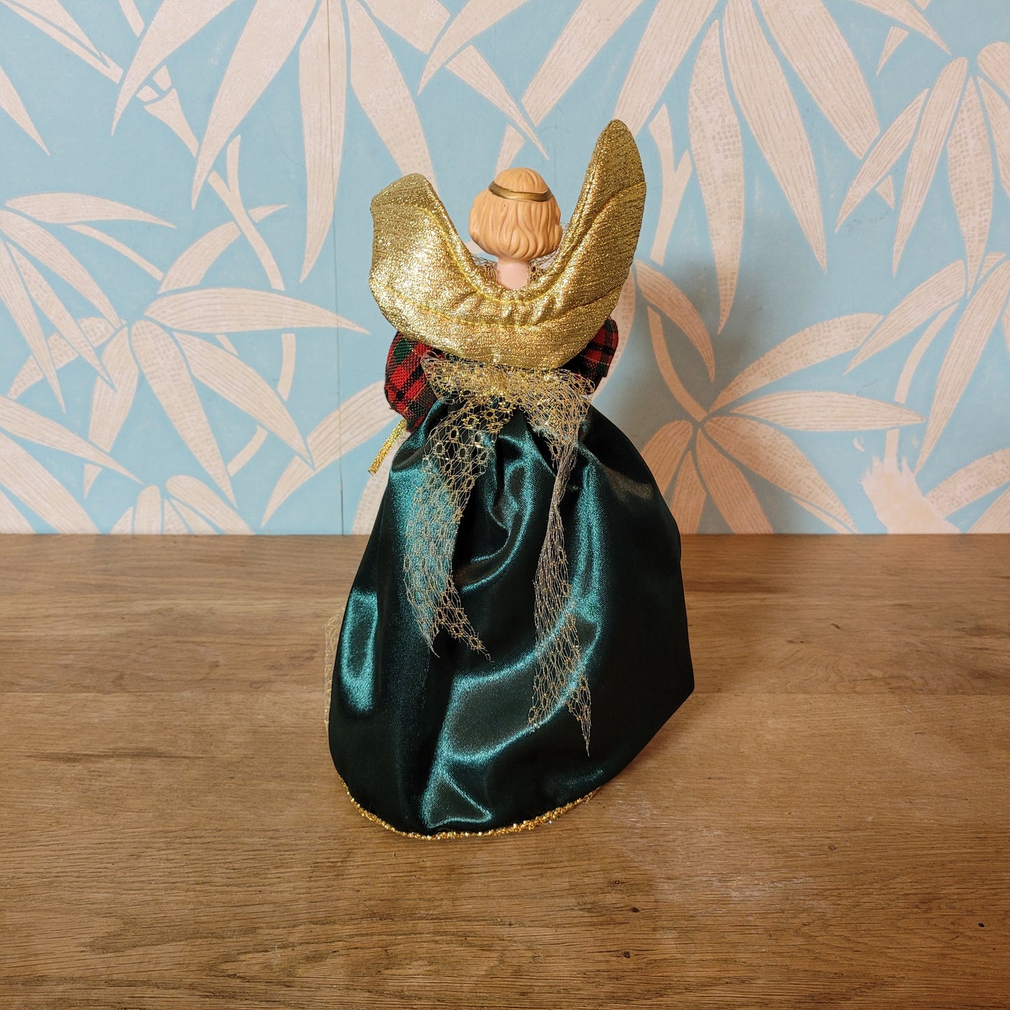 Vintage angel tree topper in plaid-sleeved green dress with porcelain face and hands