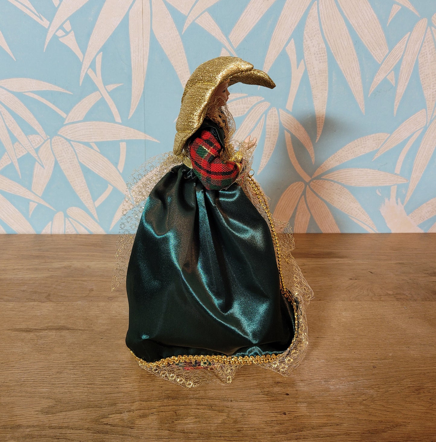 Vintage angel tree topper in plaid-sleeved green dress with porcelain face and hands