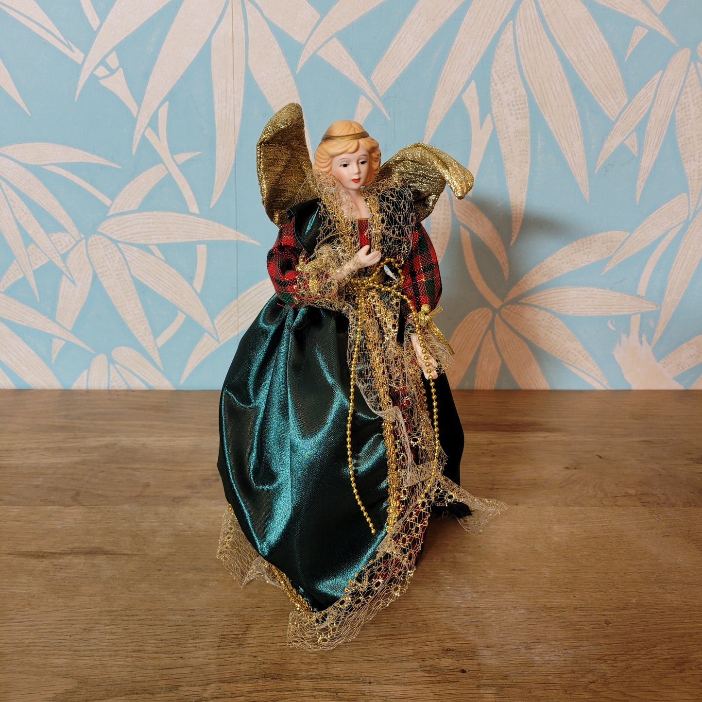 Vintage angel tree topper in plaid-sleeved green dress with porcelain face and hands