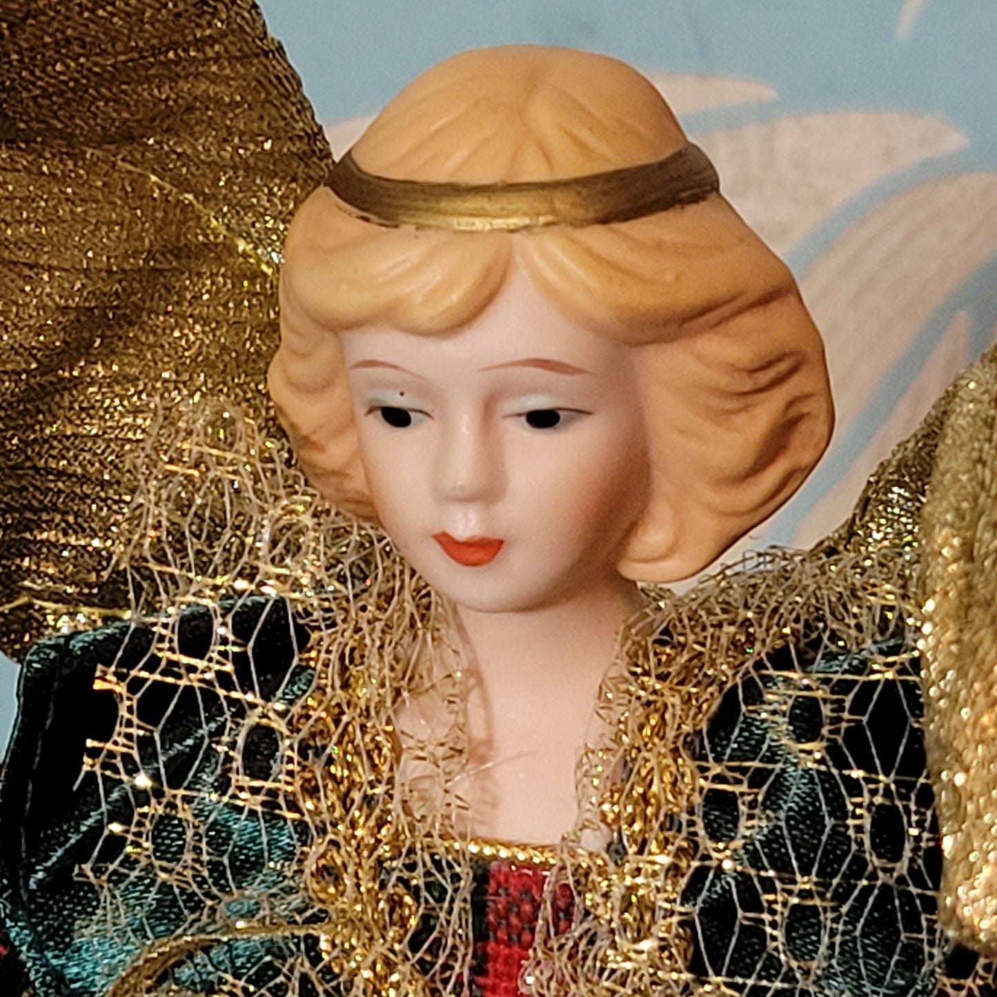 Vintage angel tree topper in plaid-sleeved green dress with porcelain face and hands