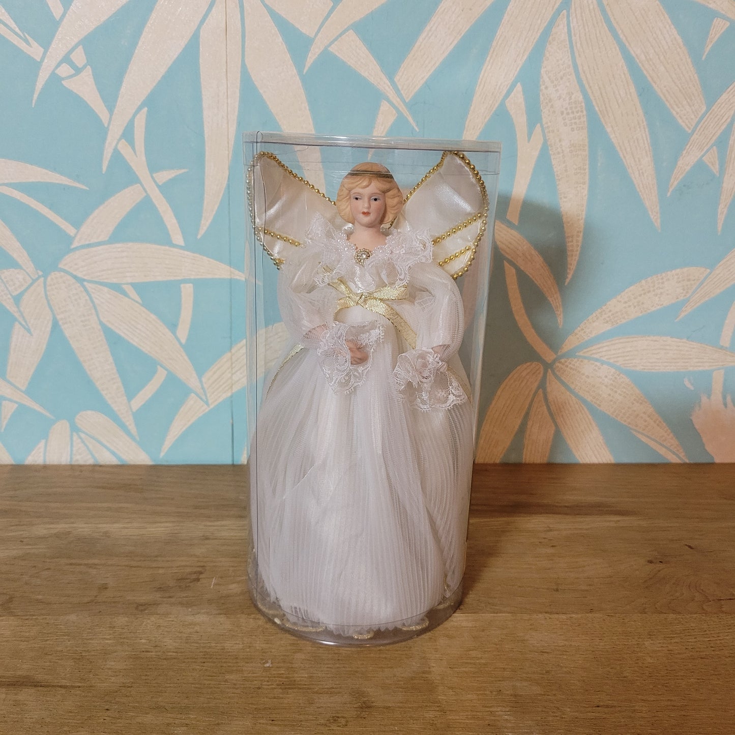 Vintage Victorian-style angel tree topper in white dress with pleated overskirt