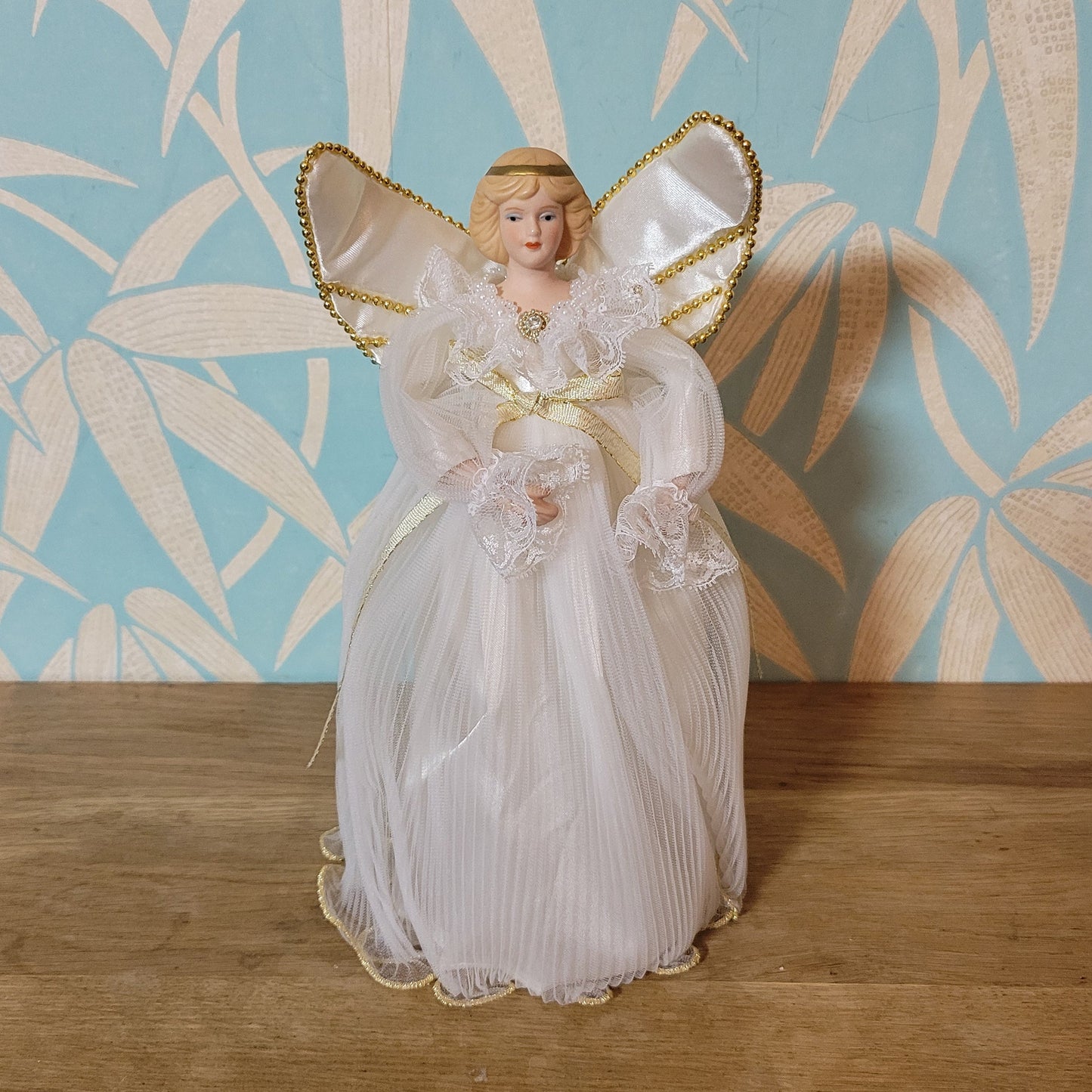Vintage Victorian-style angel tree topper in white dress with pleated overskirt