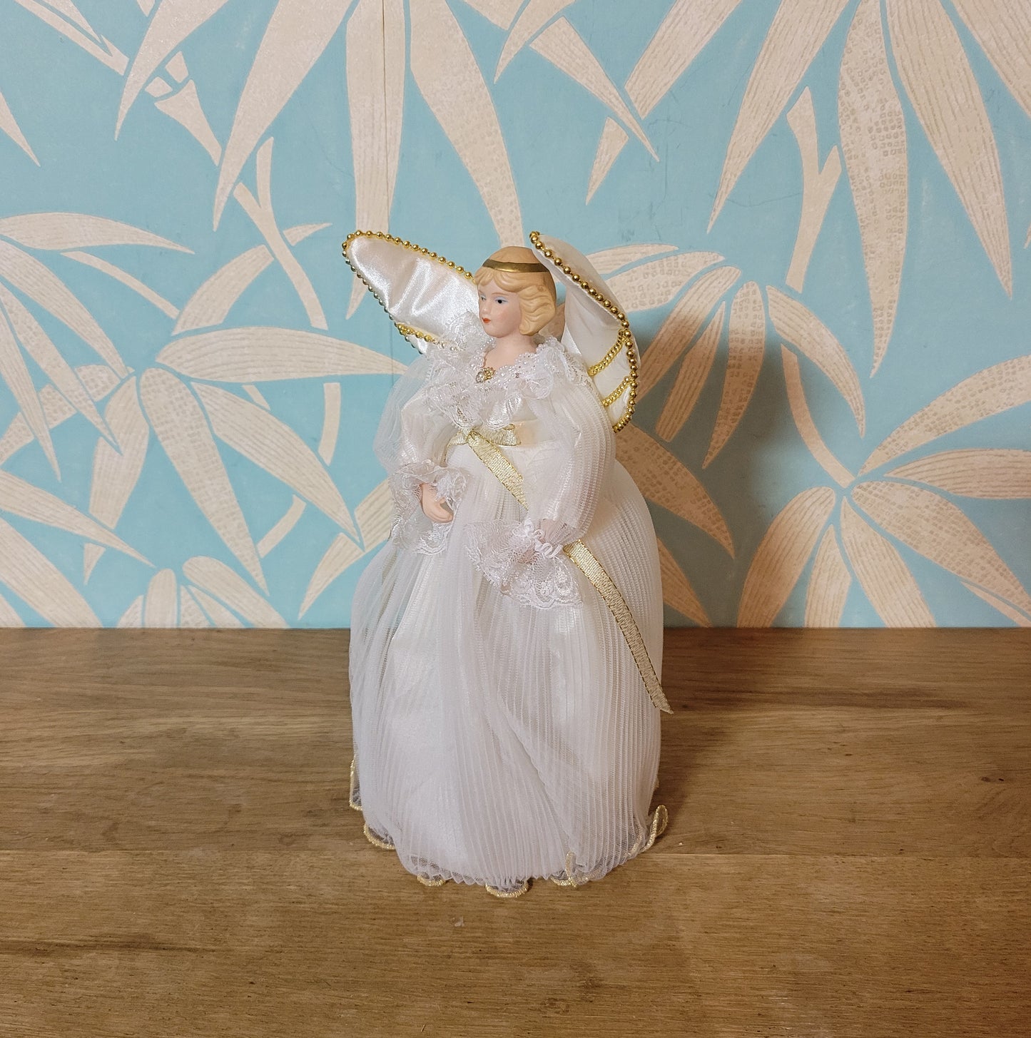 Vintage Victorian-style angel tree topper in white dress with pleated overskirt