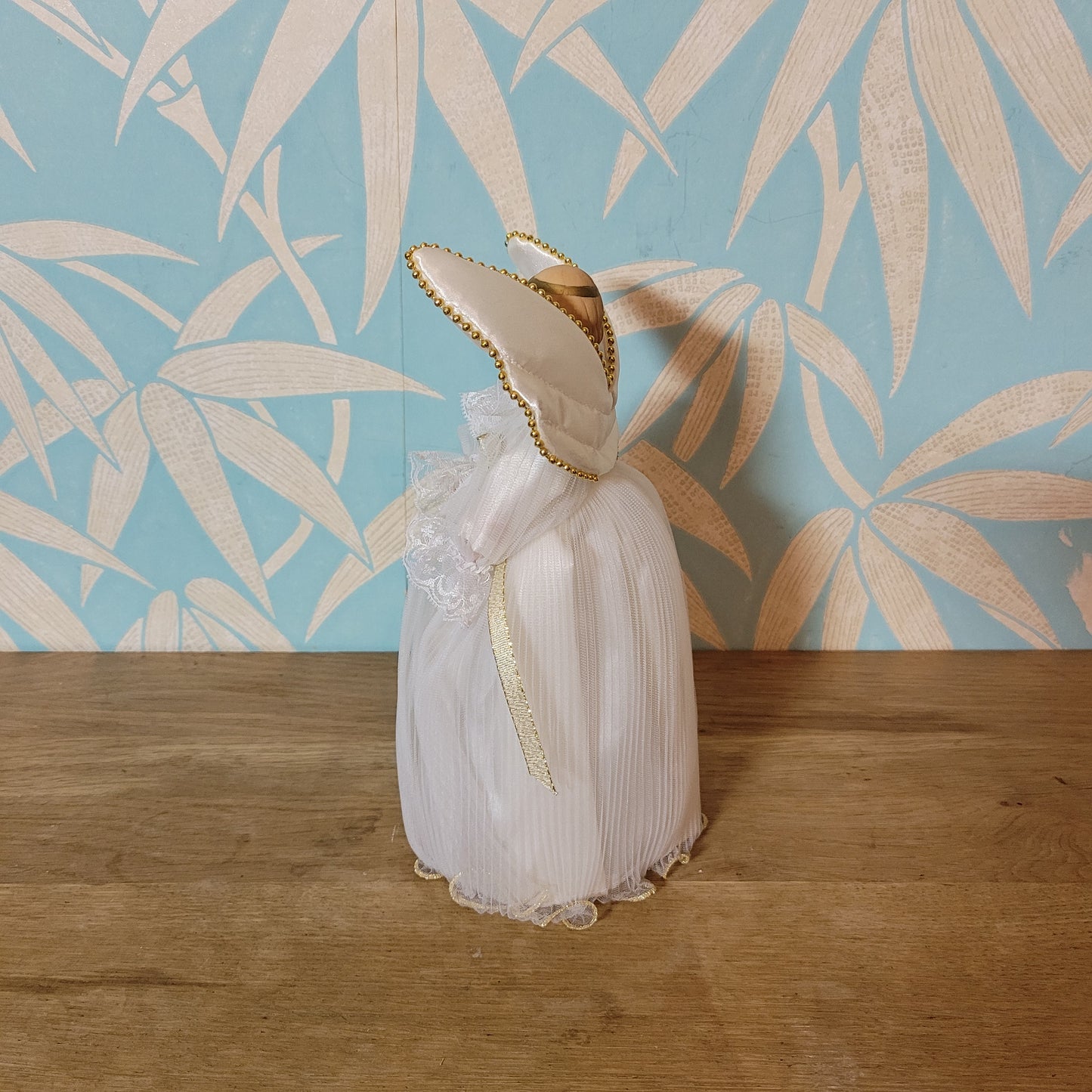 Vintage Victorian-style angel tree topper in white dress with pleated overskirt