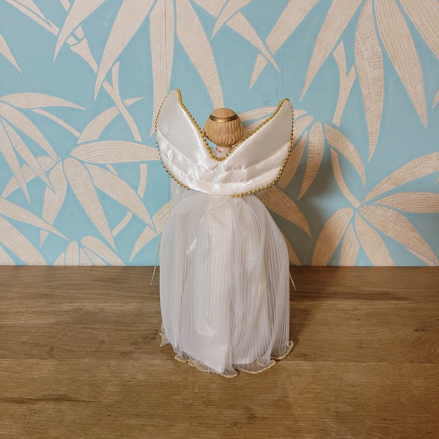 Vintage Victorian-style angel tree topper in white dress with pleated overskirt
