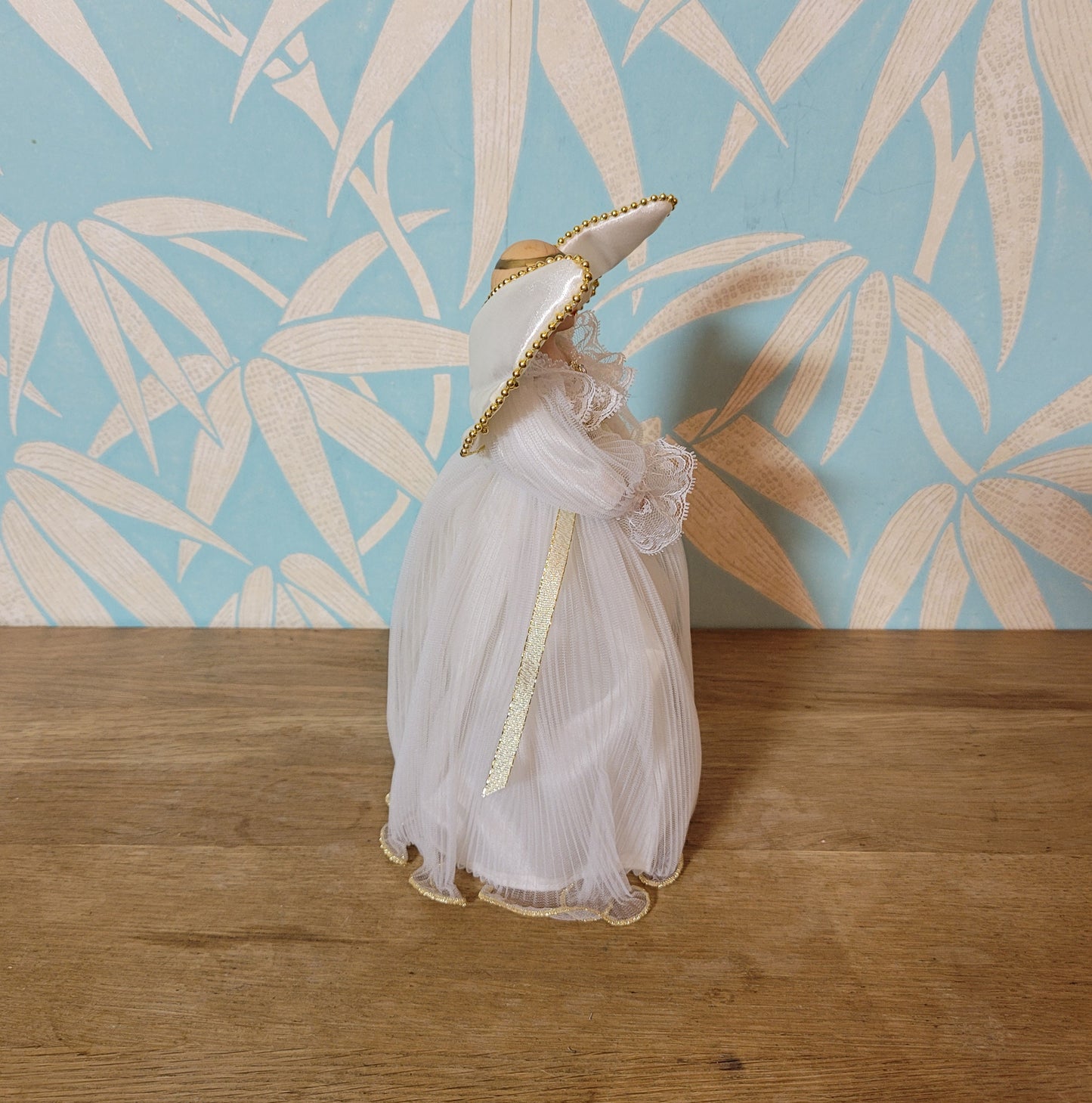 Vintage Victorian-style angel tree topper in white dress with pleated overskirt