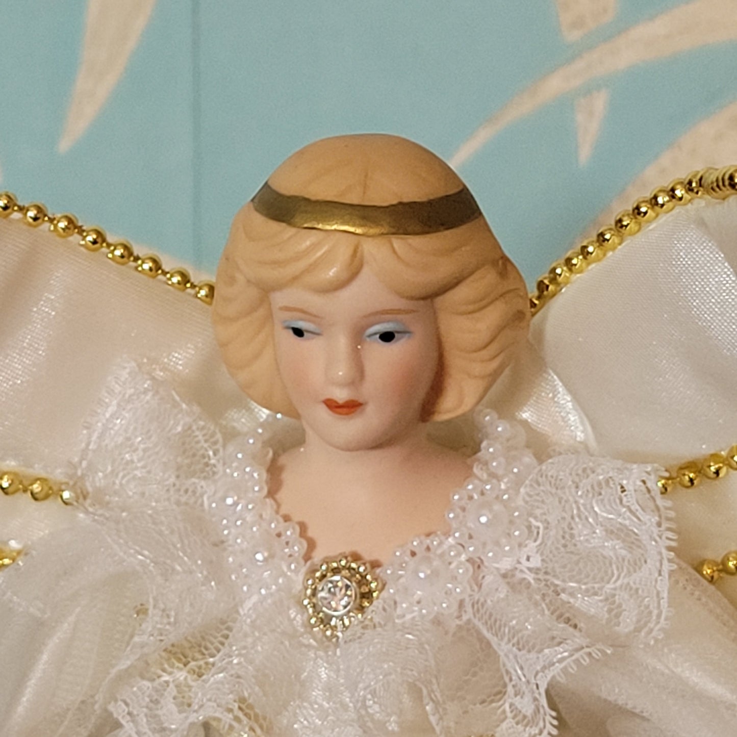 Vintage Victorian-style angel tree topper in white dress with pleated overskirt
