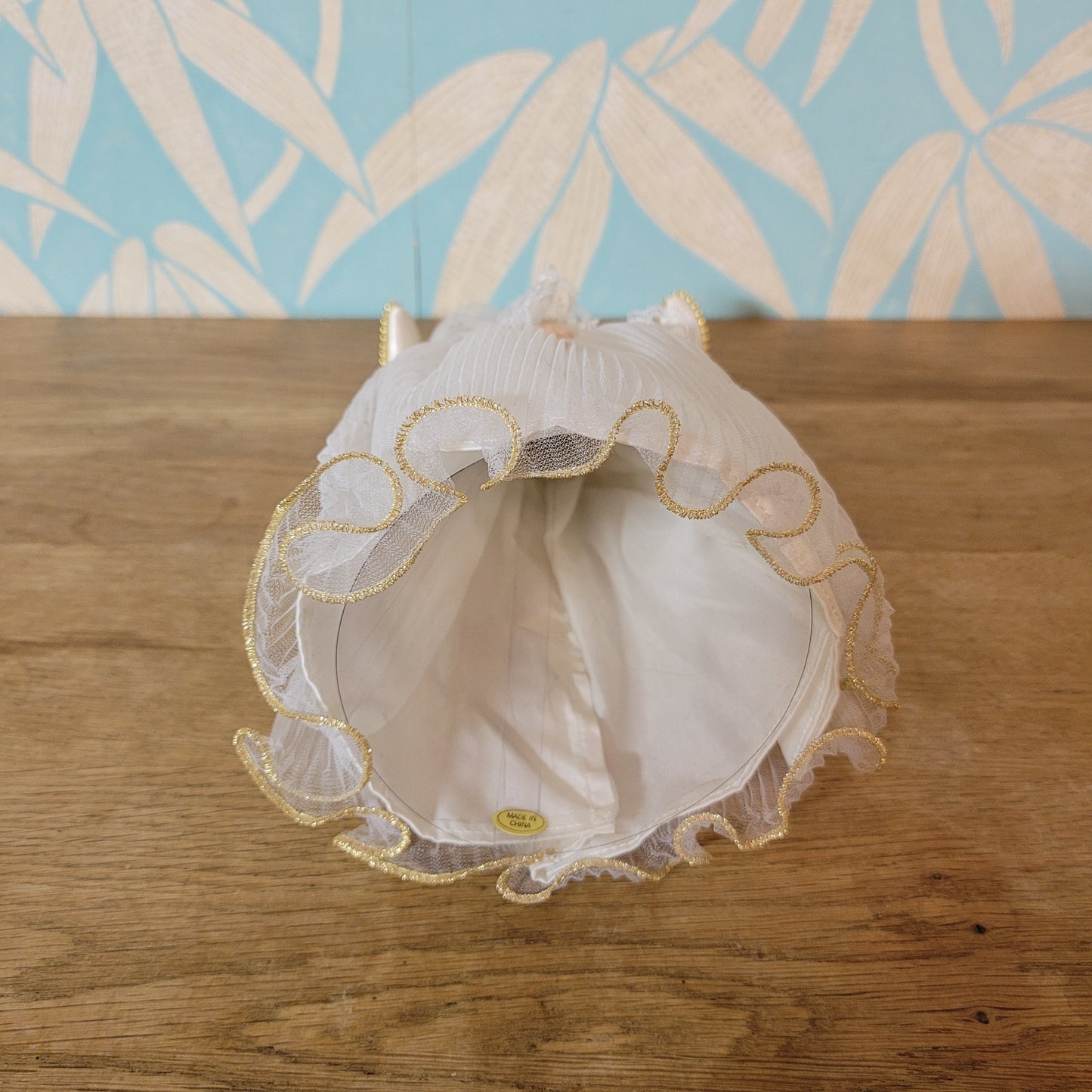 Vintage Victorian-style angel tree topper in white dress with pleated overskirt