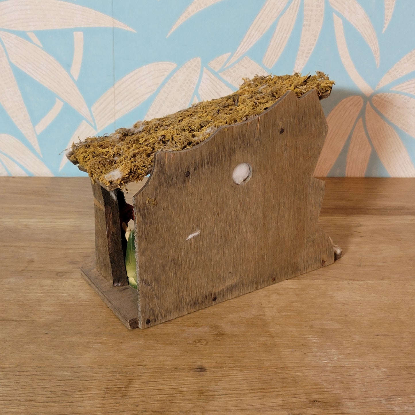 Vintage traditional nativity scene with plastic figures in wooden stable