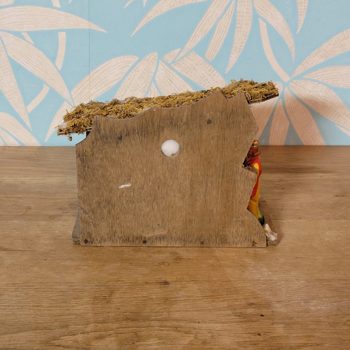 Vintage traditional nativity scene with plastic figures in wooden stable
