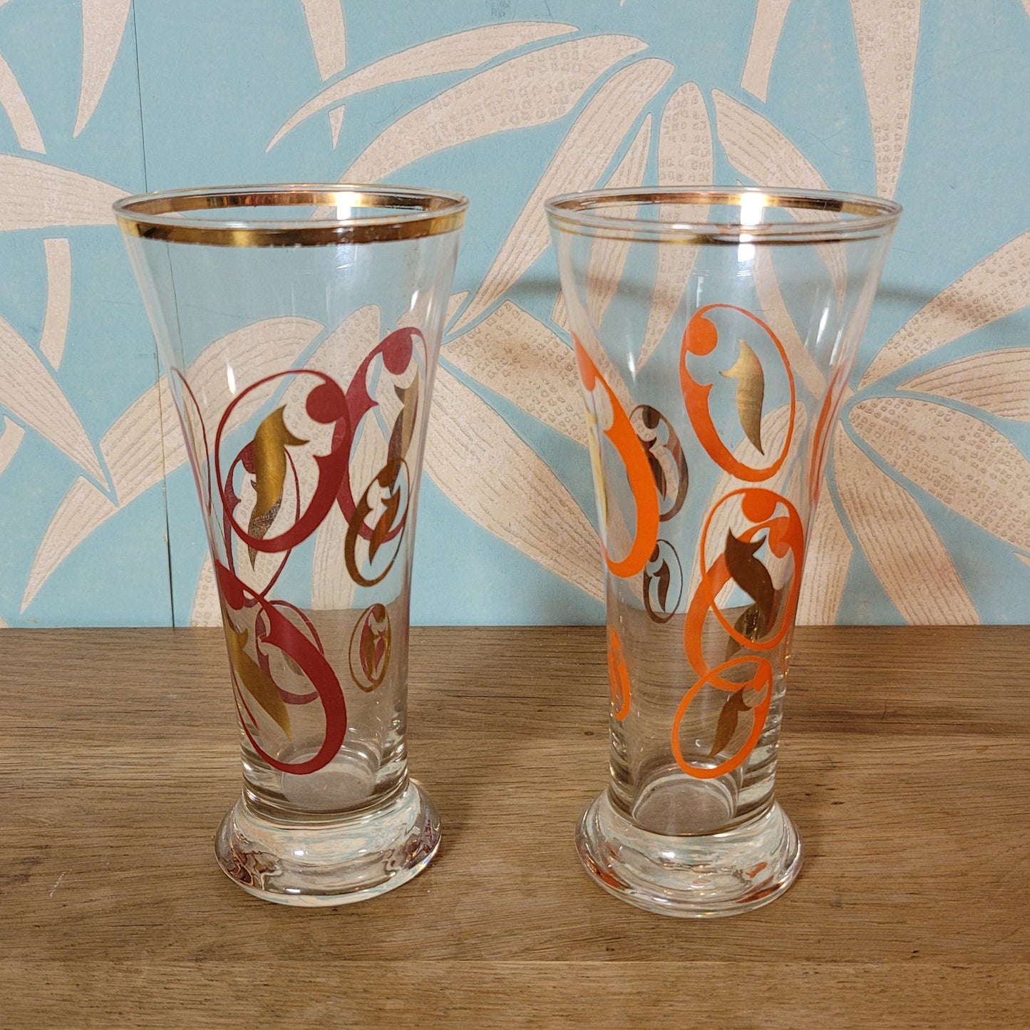 Pair of 1960s atomic swirl pilsner glasses with gilt detail