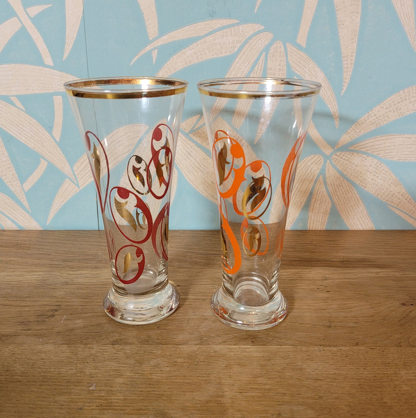 Pair of 1960s atomic swirl pilsner glasses with gilt detail