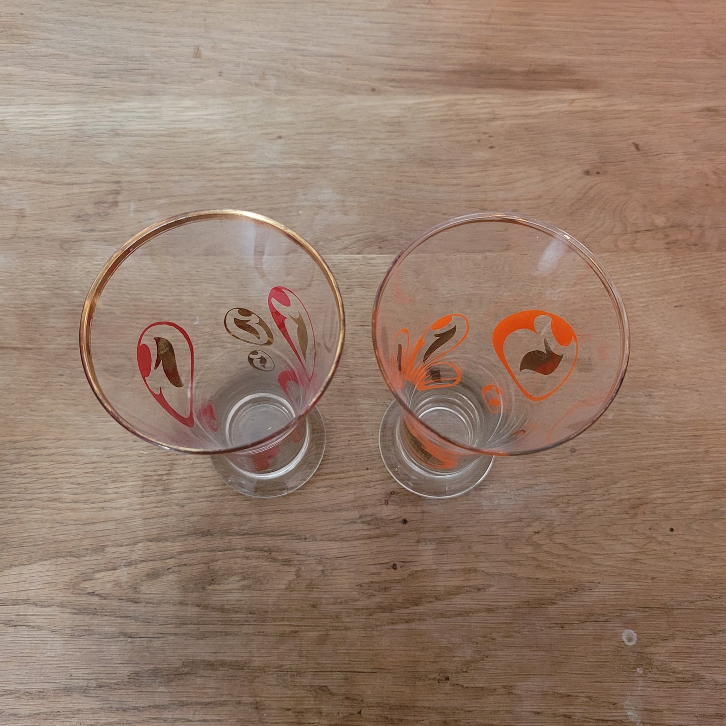 Pair of 1960s atomic swirl pilsner glasses with gilt detail