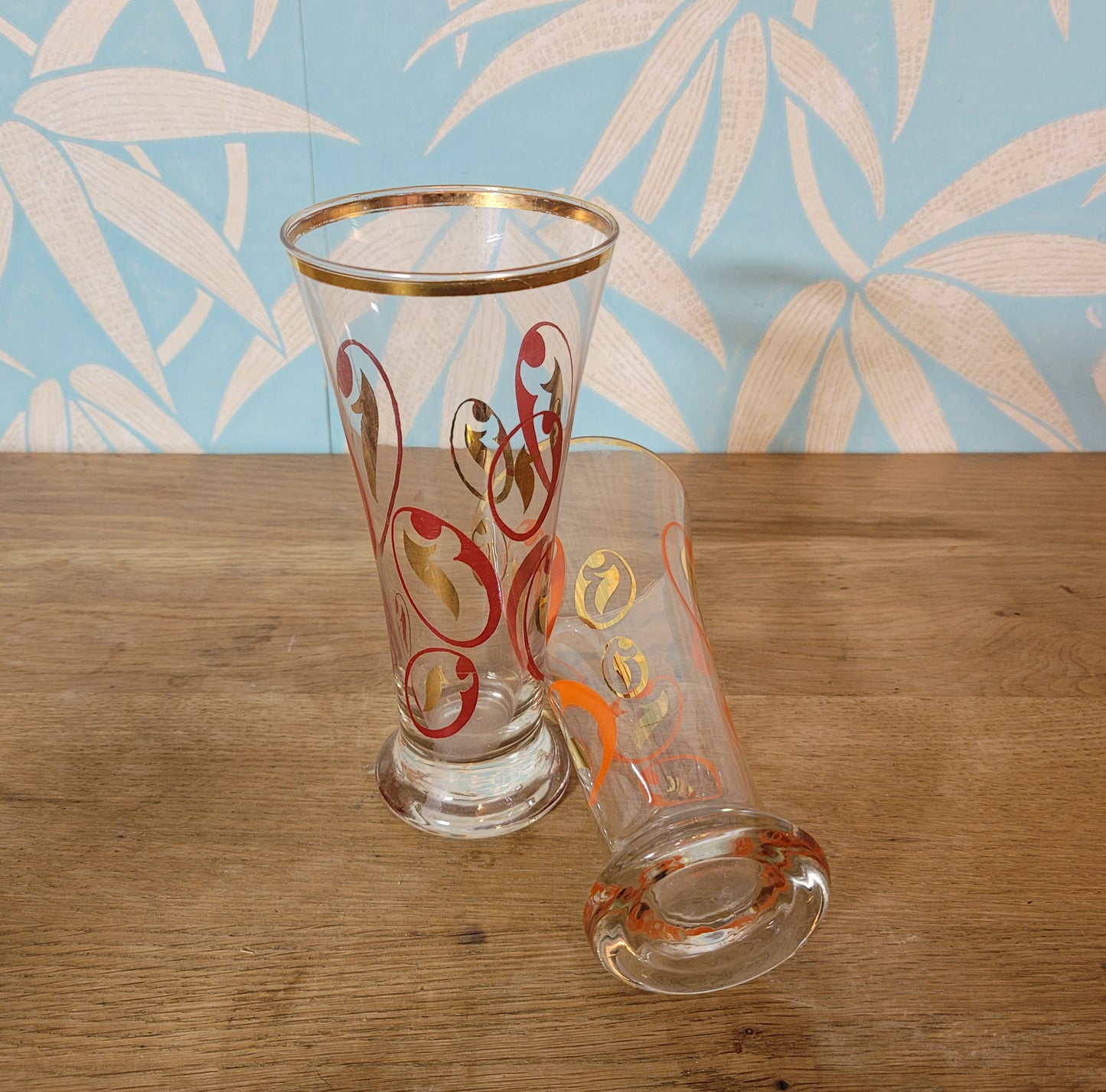 Pair of 1960s atomic swirl pilsner glasses with gilt detail