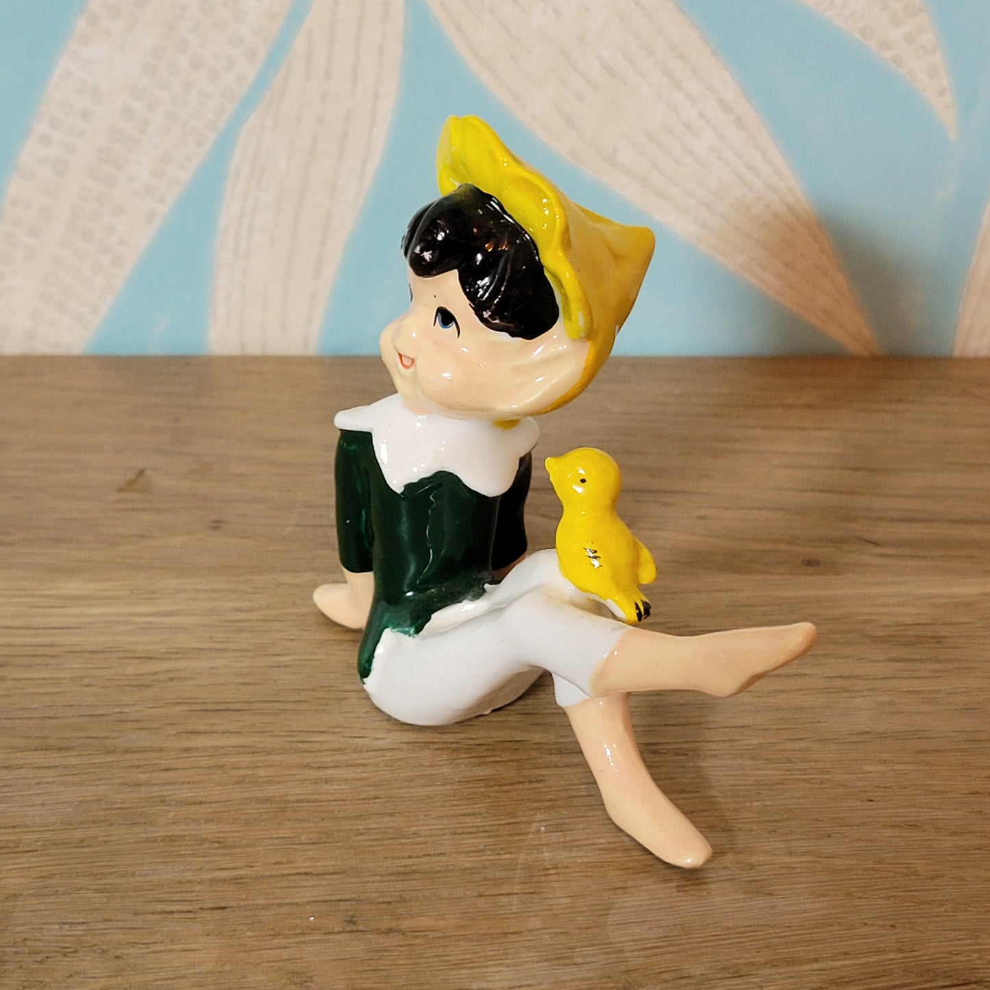 circa. 1960s ceramic pixie figurine with yellow bird