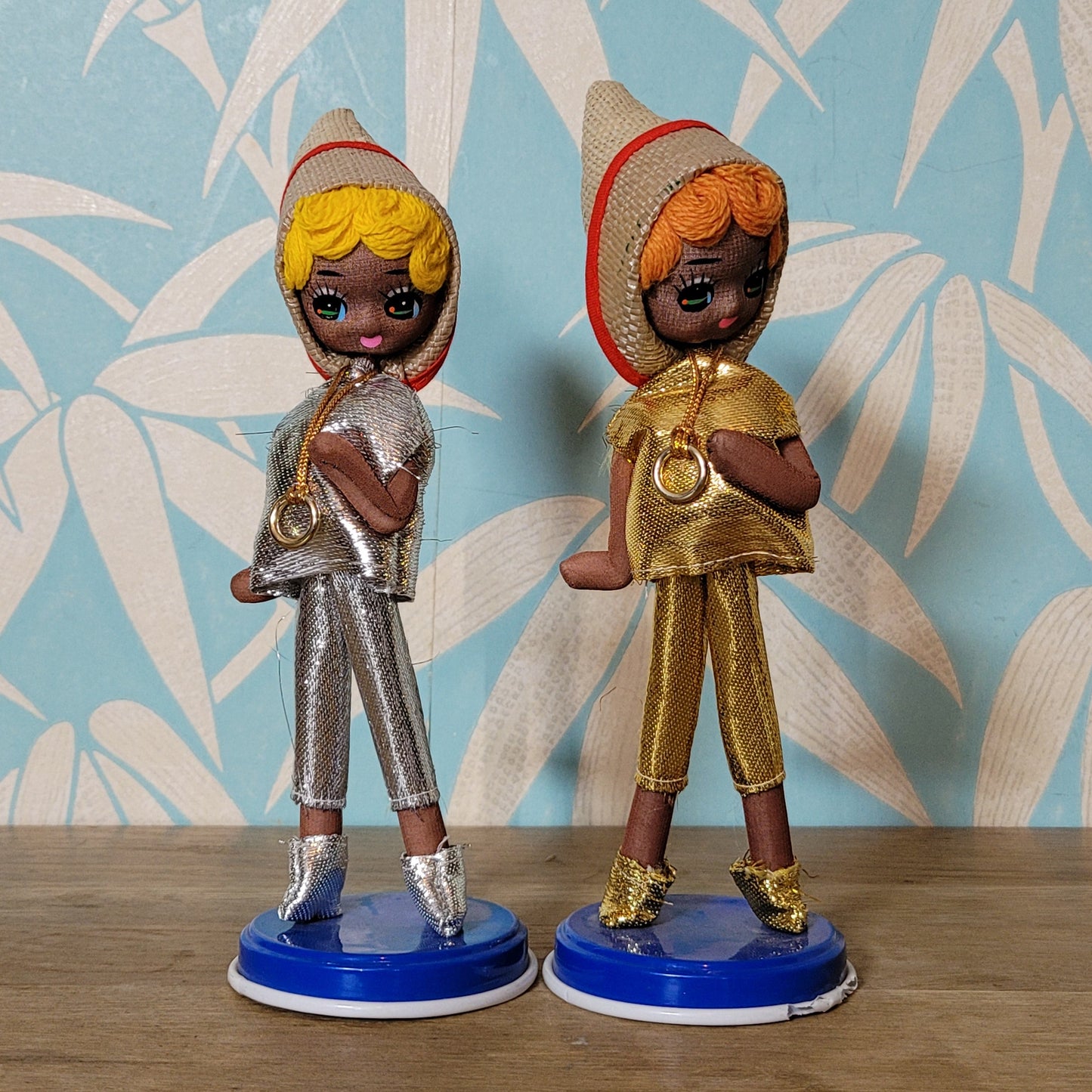 Pair of cute 1960s Bradley big eye pose dolls in co-ordinating metallic silver, & gold outfits