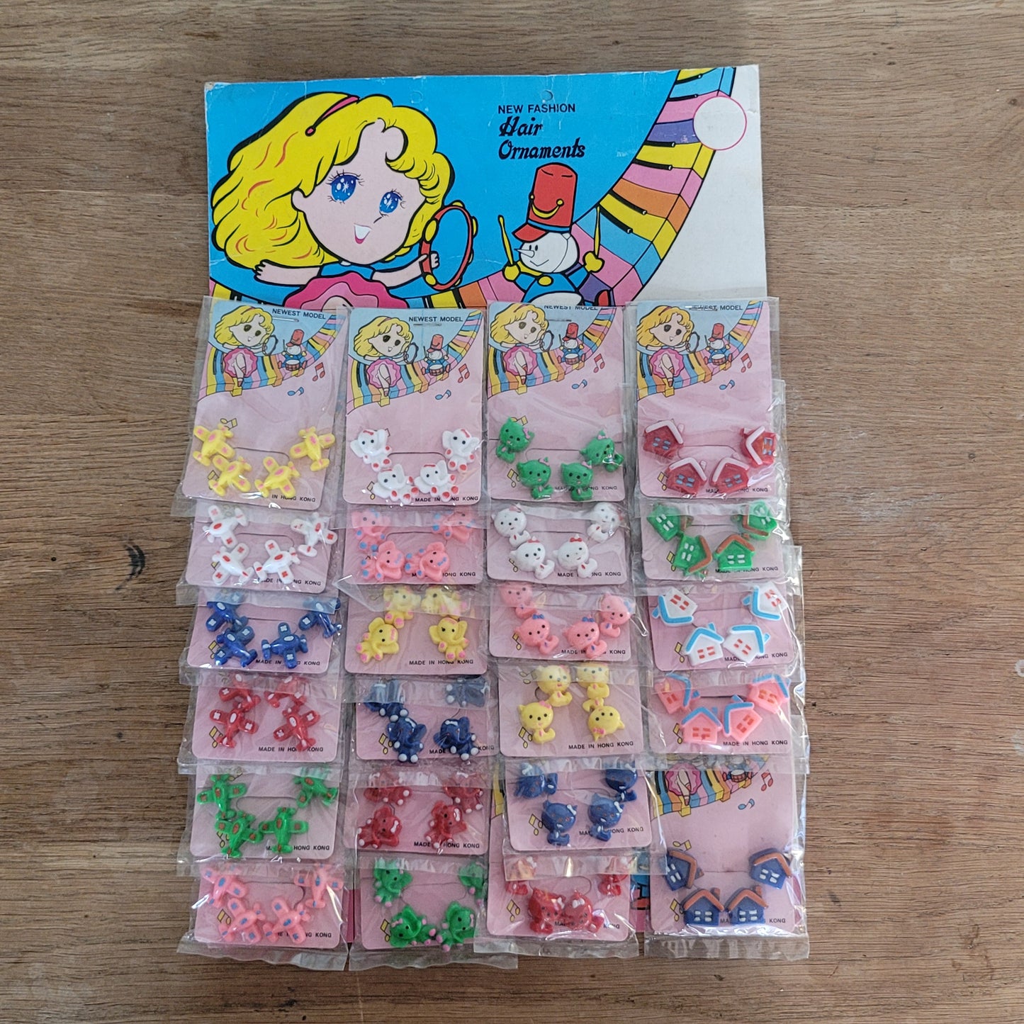 Deadstock sheet display of vintage 'New Fashion' novelty plastic hair bobbles