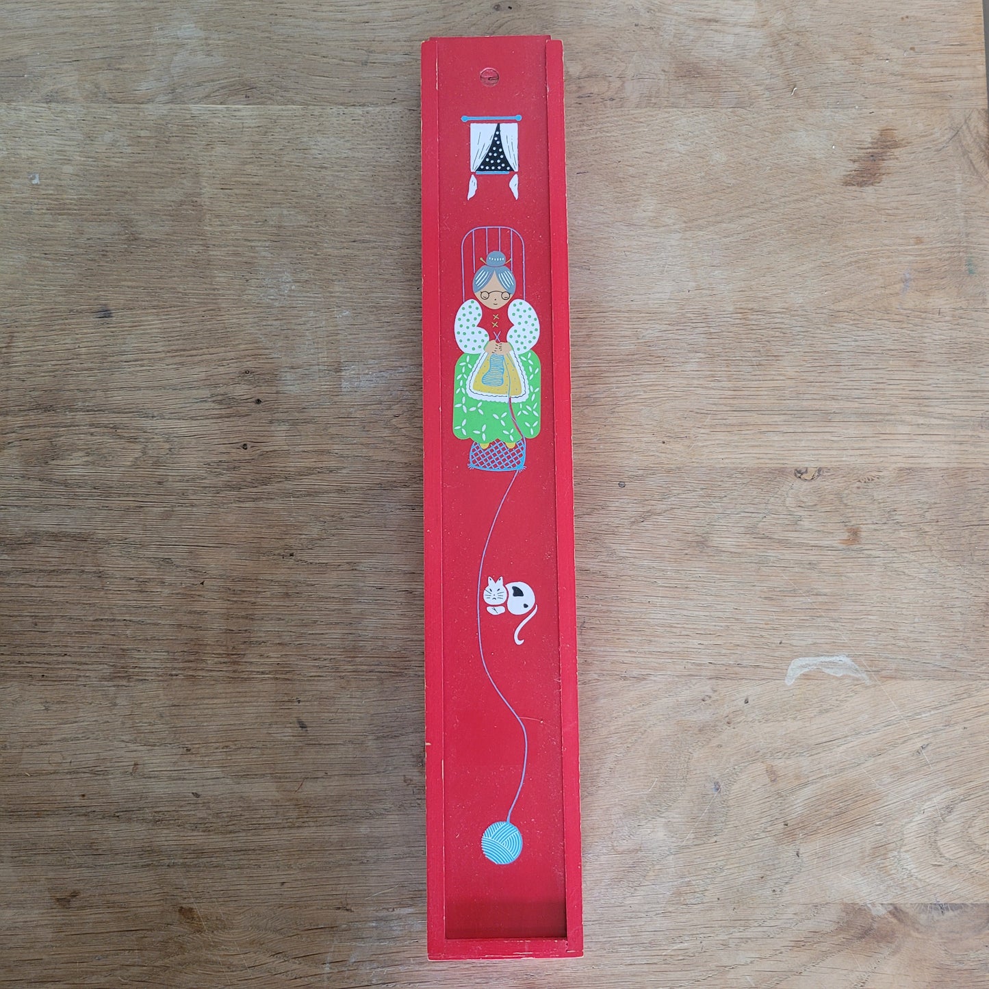 1970s red wooden knitting needle box with sliding lid, granny knitting motif