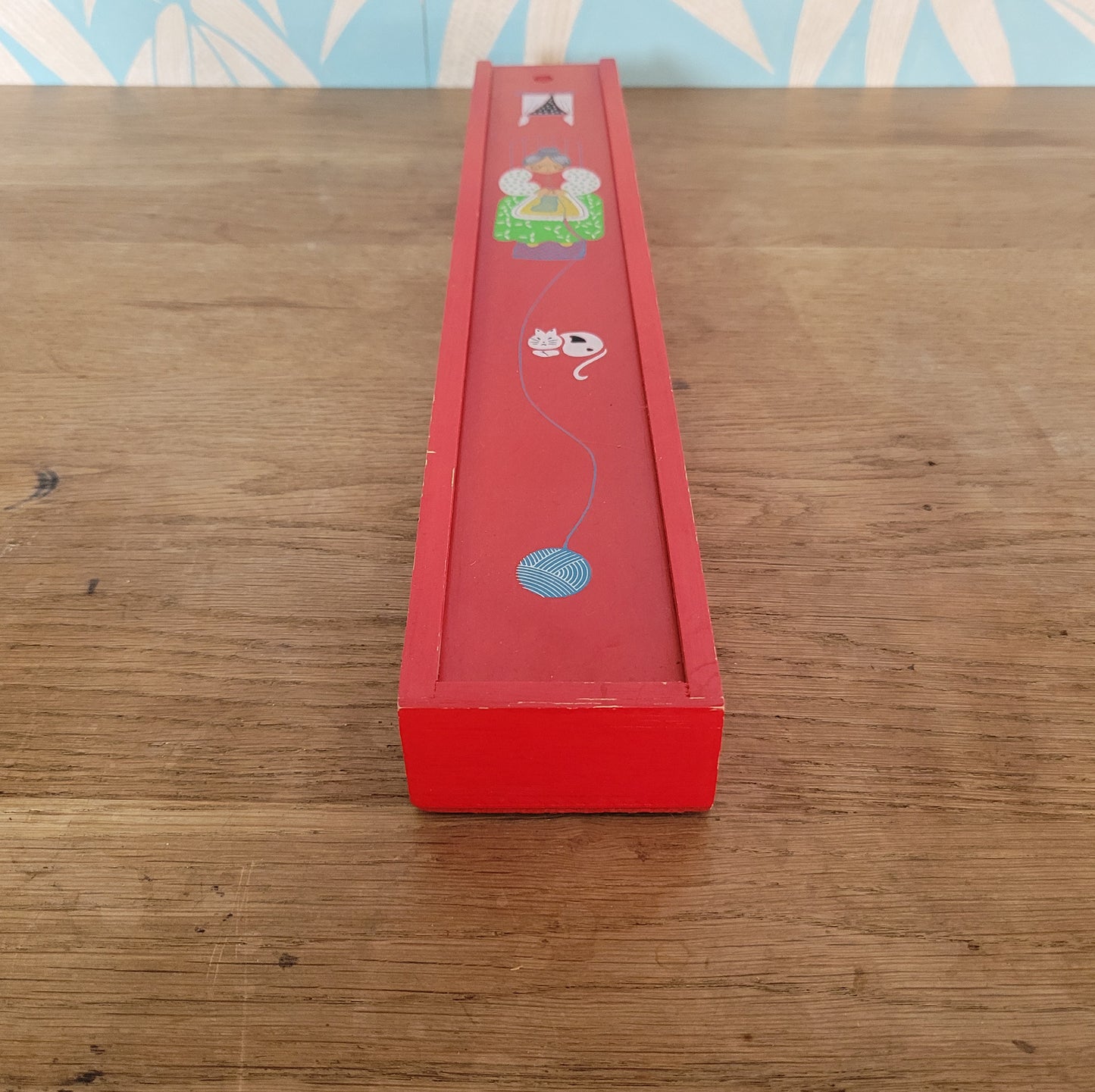 1970s red wooden knitting needle box with sliding lid, granny knitting motif
