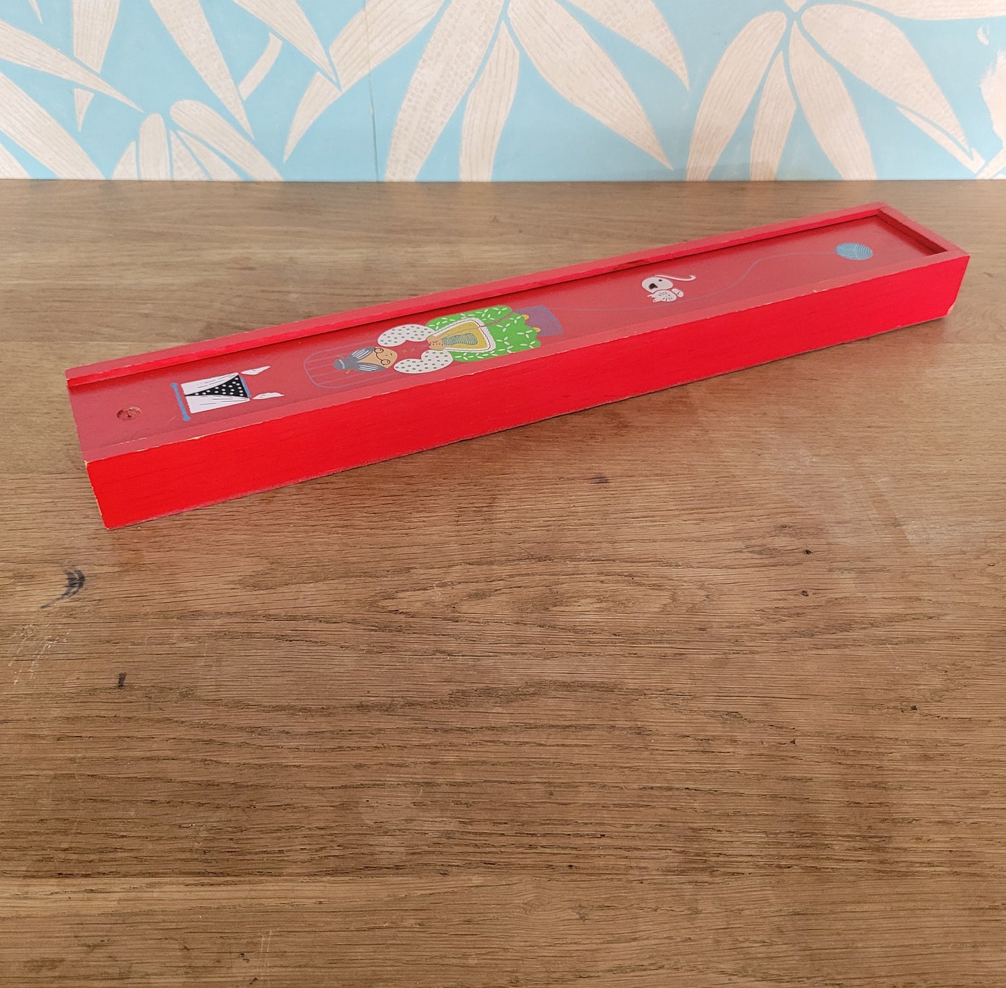 1970s red wooden knitting needle box with sliding lid, granny knitting motif