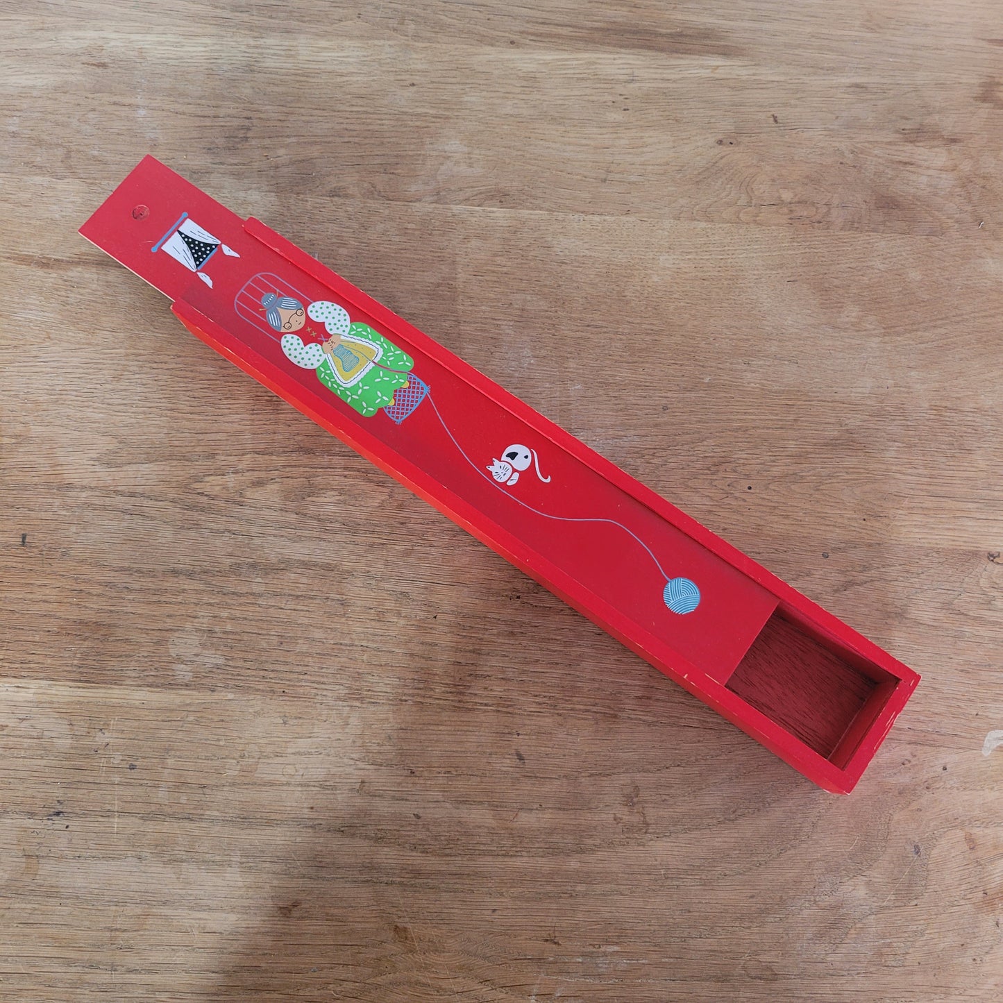 1970s red wooden knitting needle box with sliding lid, granny knitting motif