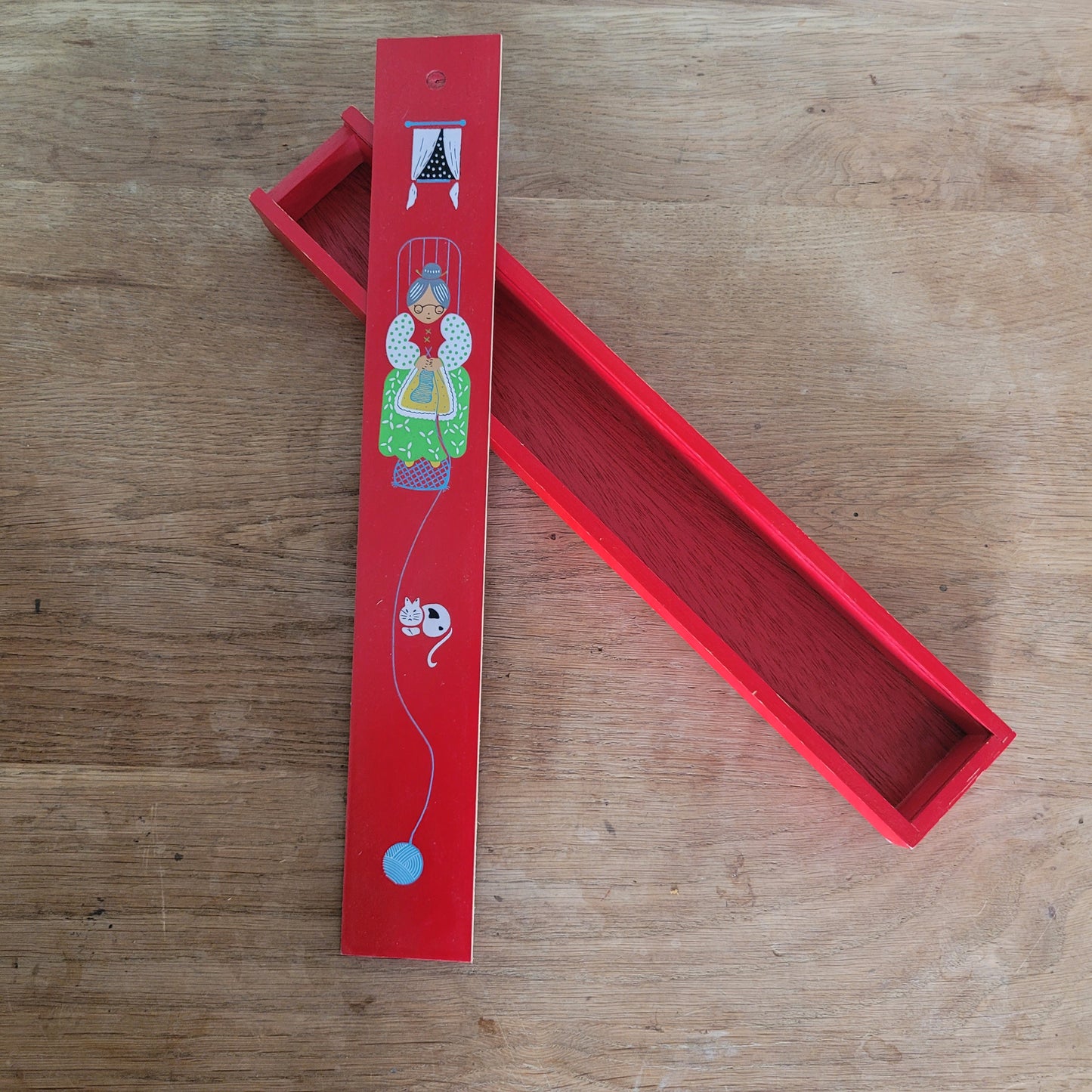 1970s red wooden knitting needle box with sliding lid, granny knitting motif