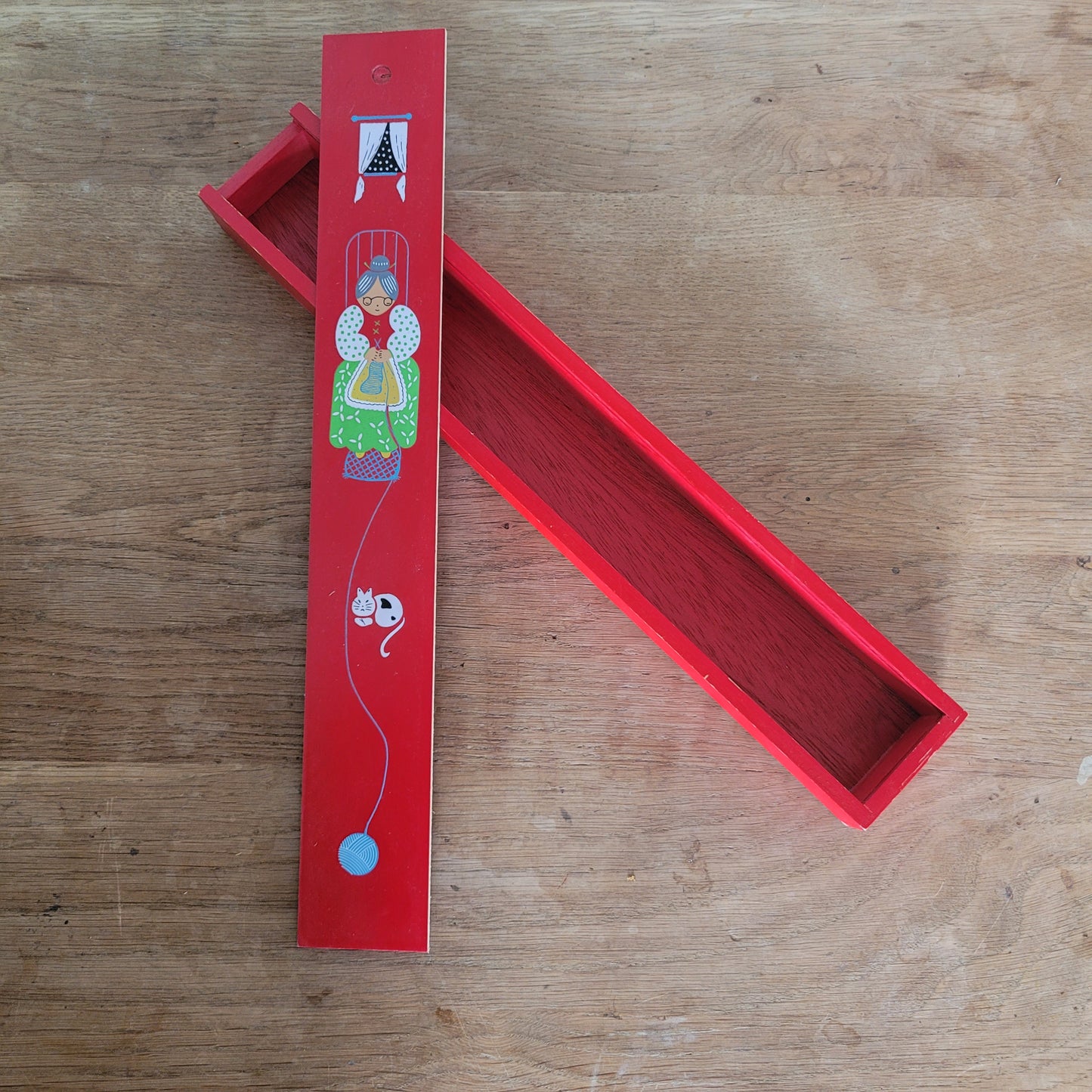 1970s red wooden knitting needle box with sliding lid, granny knitting motif
