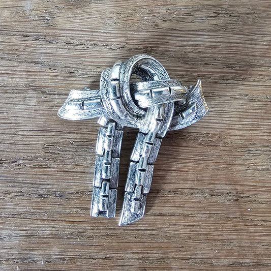 Mid-century Jewelcraft silver-tone articulated knot brooch