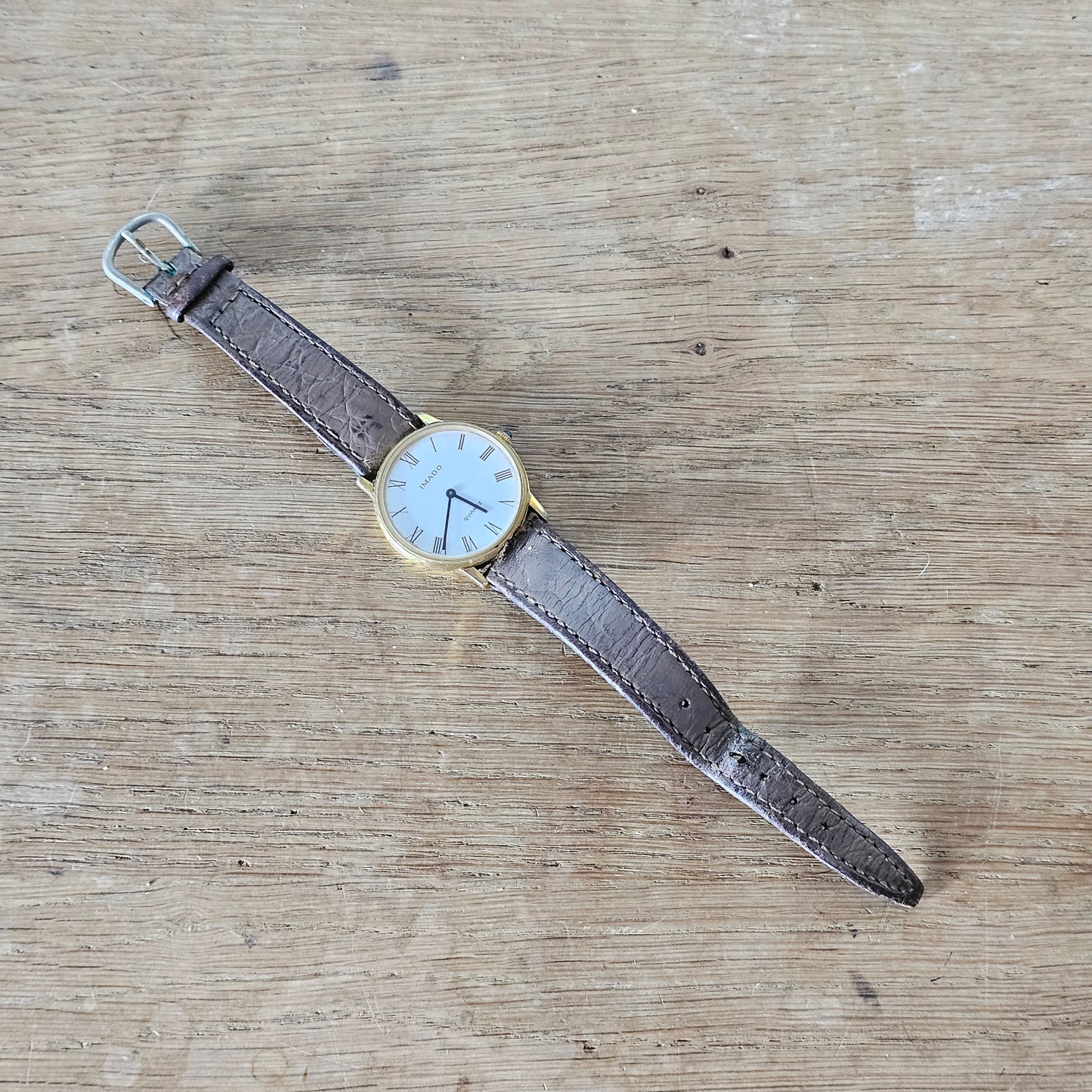 Vintage gold-tone Imado Quartz Roman numeral men's watch with leather strap