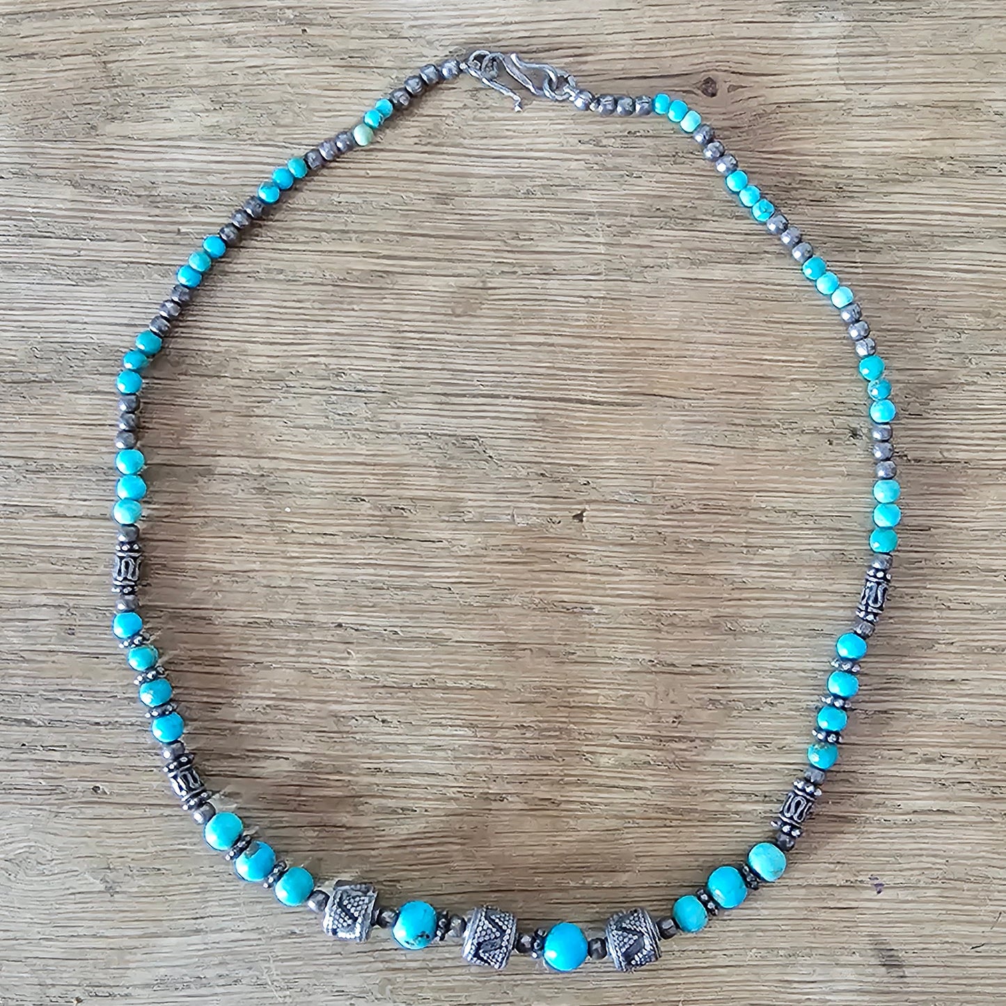 1990s turquoise stone bead necklace with tribal style silver tone spacers