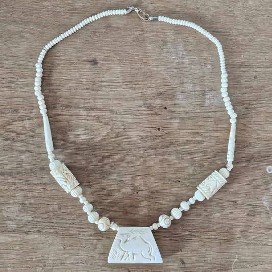 circa. 1970s ivory-tone bone necklace with carved animal detail