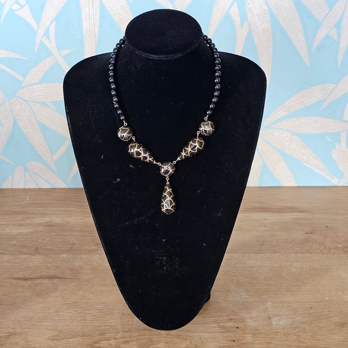 1980s black lucite bead drop necklace with gold glitter pattern detail
