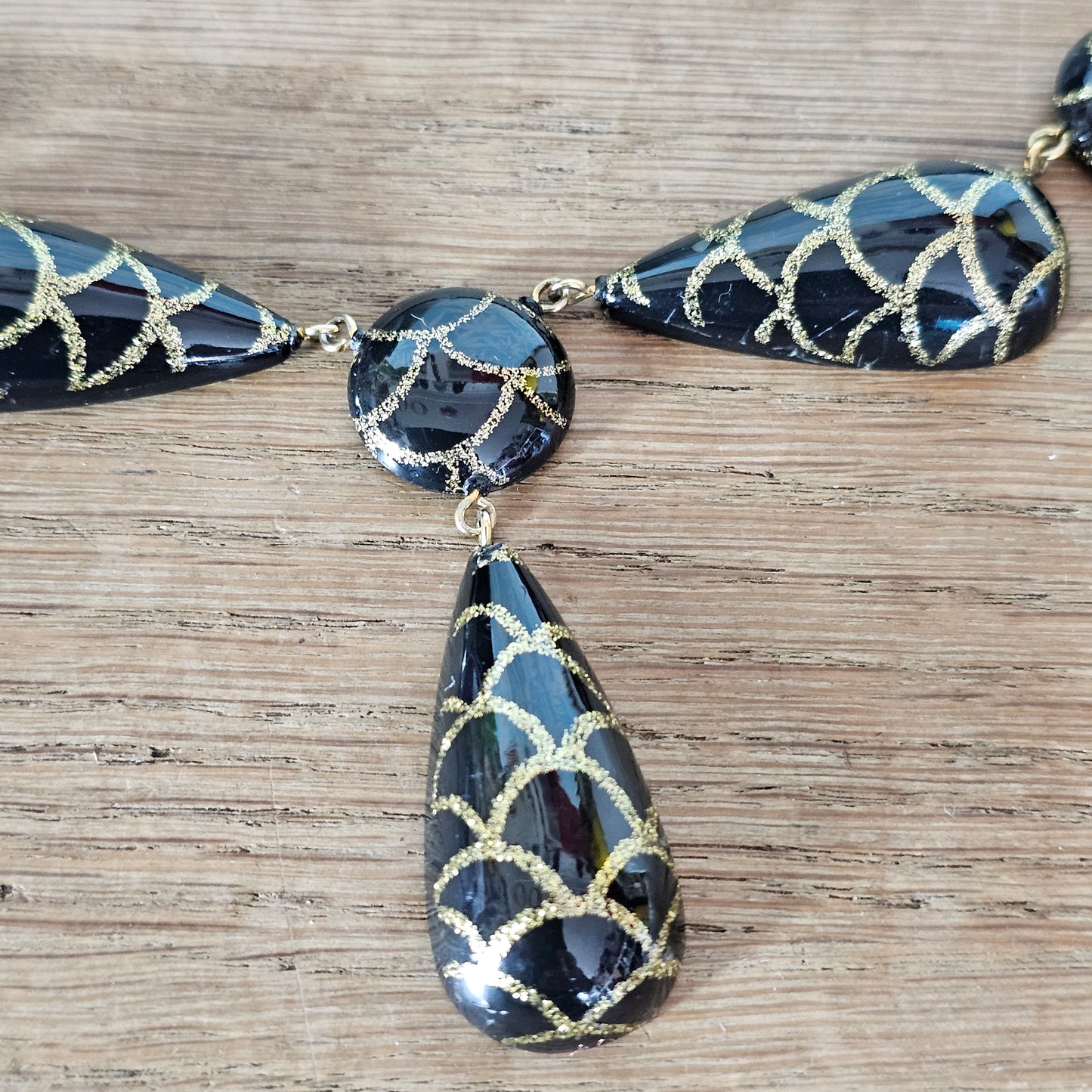 1980s black lucite bead drop necklace with gold glitter pattern detail