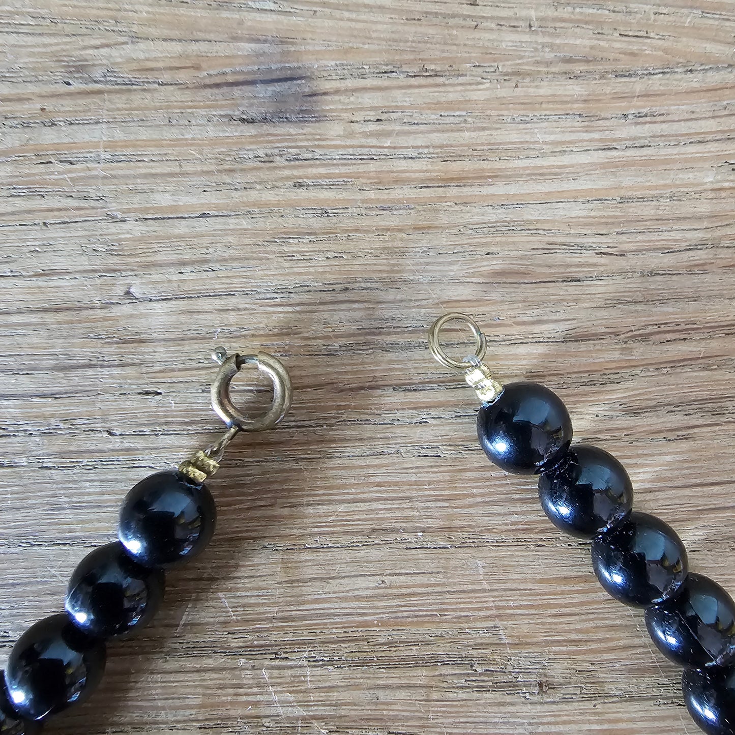 1980s black lucite bead drop necklace with gold glitter pattern detail
