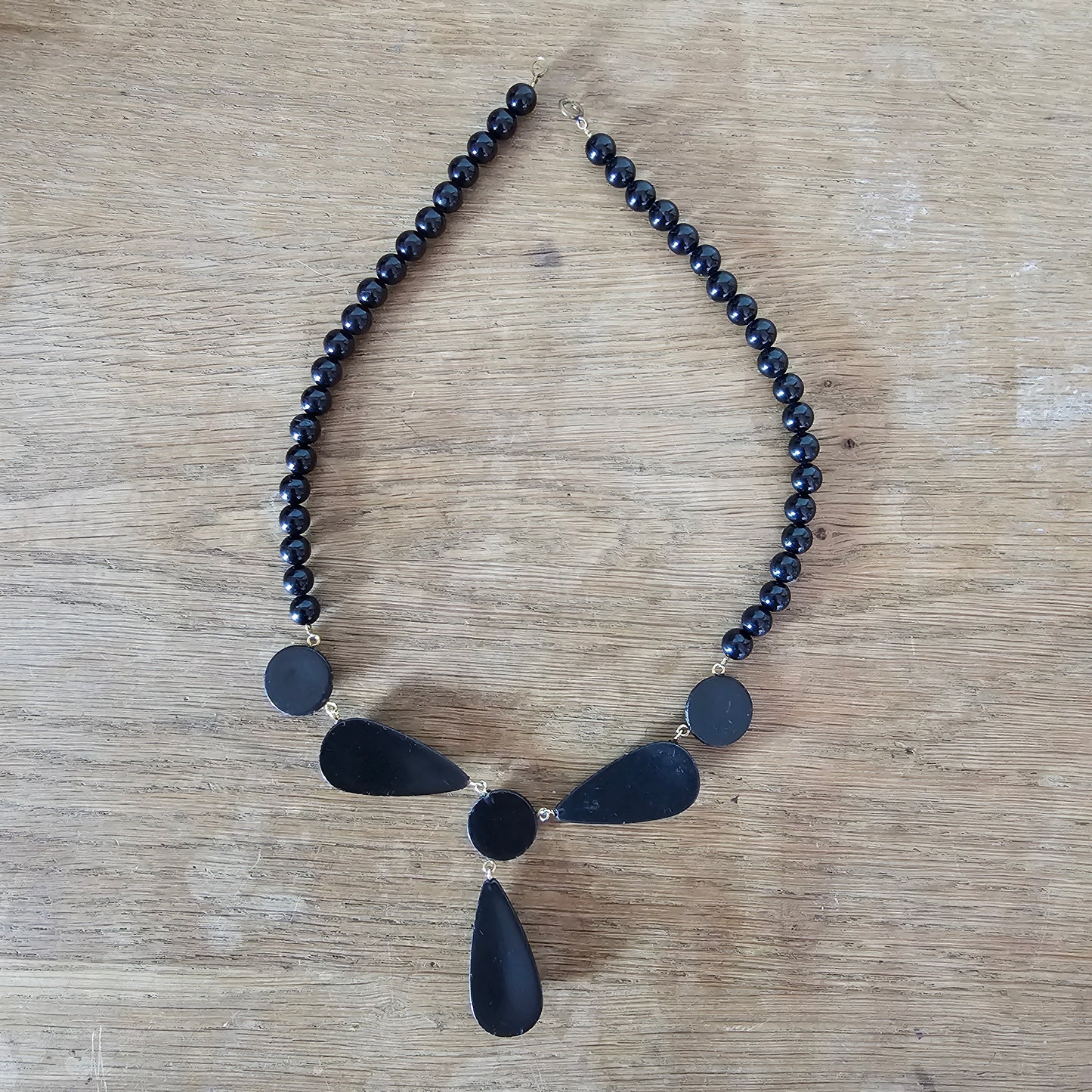1980s black lucite bead drop necklace with gold glitter pattern detail