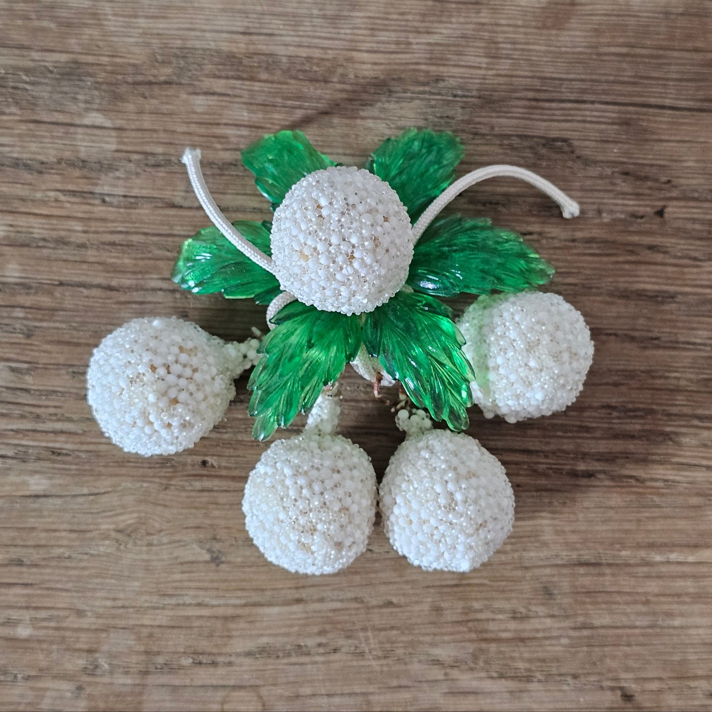 1940s white seed bead cluster fruit brooch with green lucite leaves