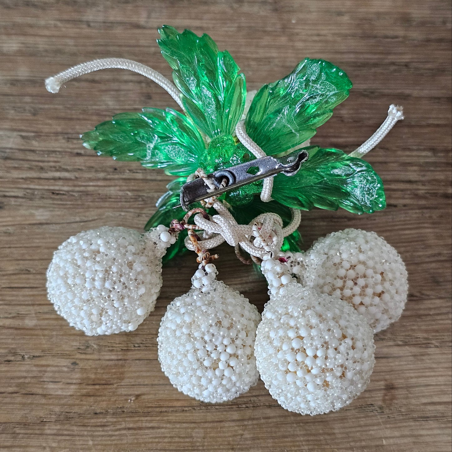 1940s white seed bead cluster fruit brooch with green lucite leaves