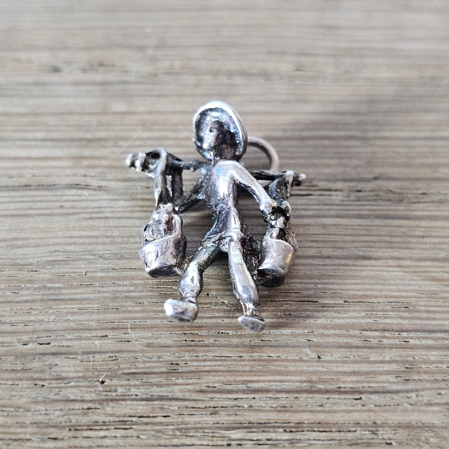 circa. 1970s silver-tone figural water carrier charm