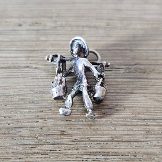 circa. 1970s silver-tone figural water carrier charm