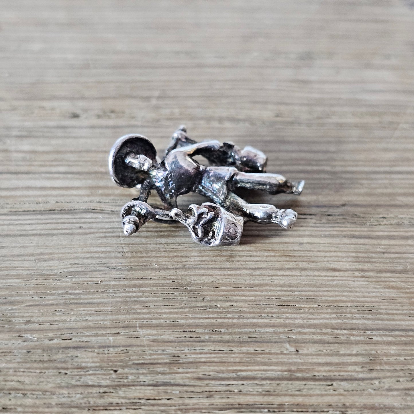 circa. 1970s silver-tone figural water carrier charm