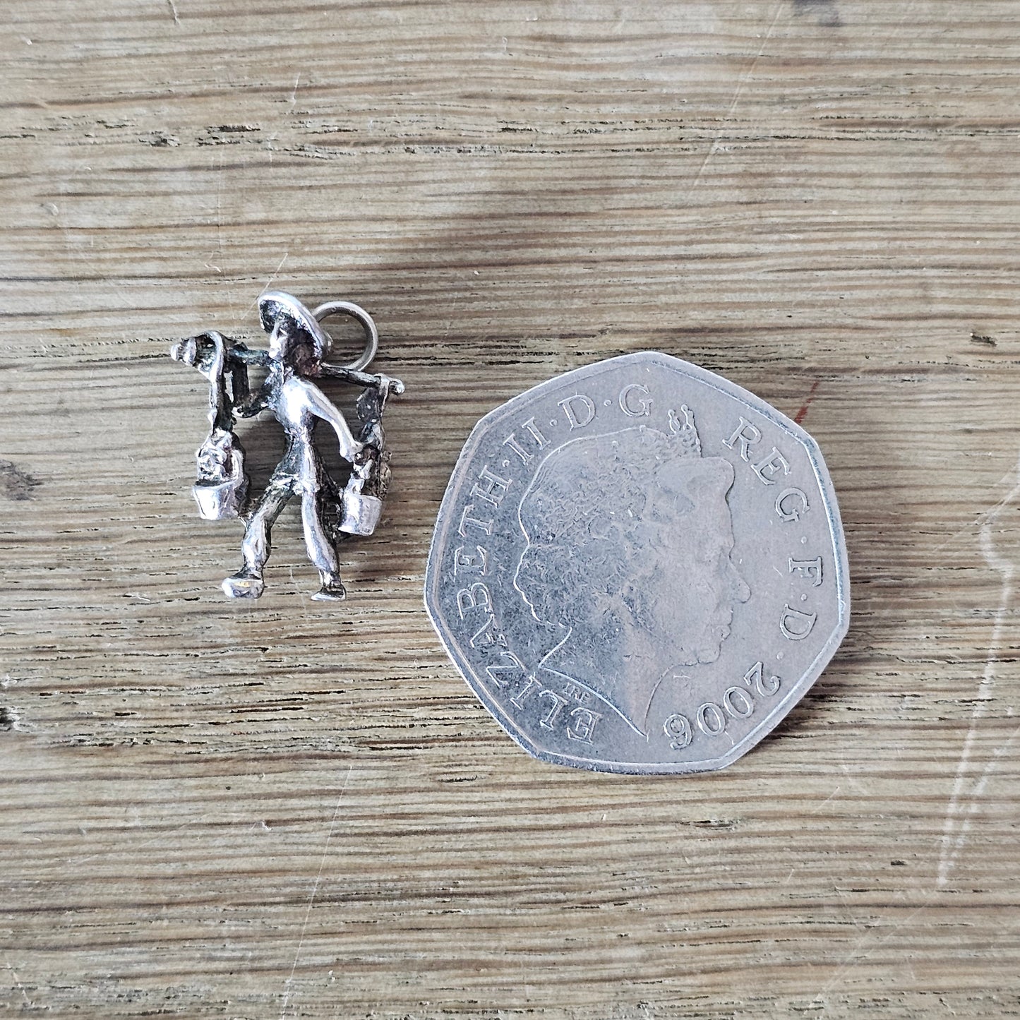 circa. 1970s silver-tone figural water carrier charm