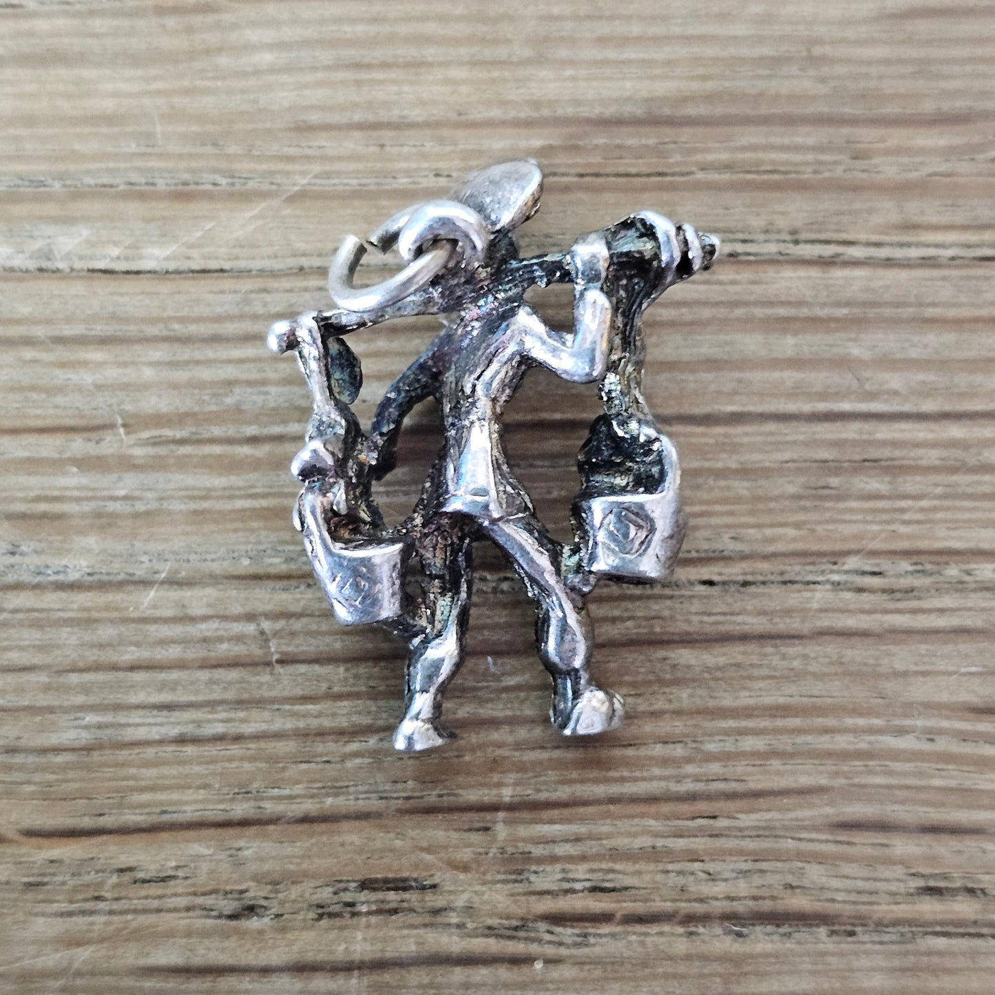 circa. 1970s silver-tone figural water carrier charm