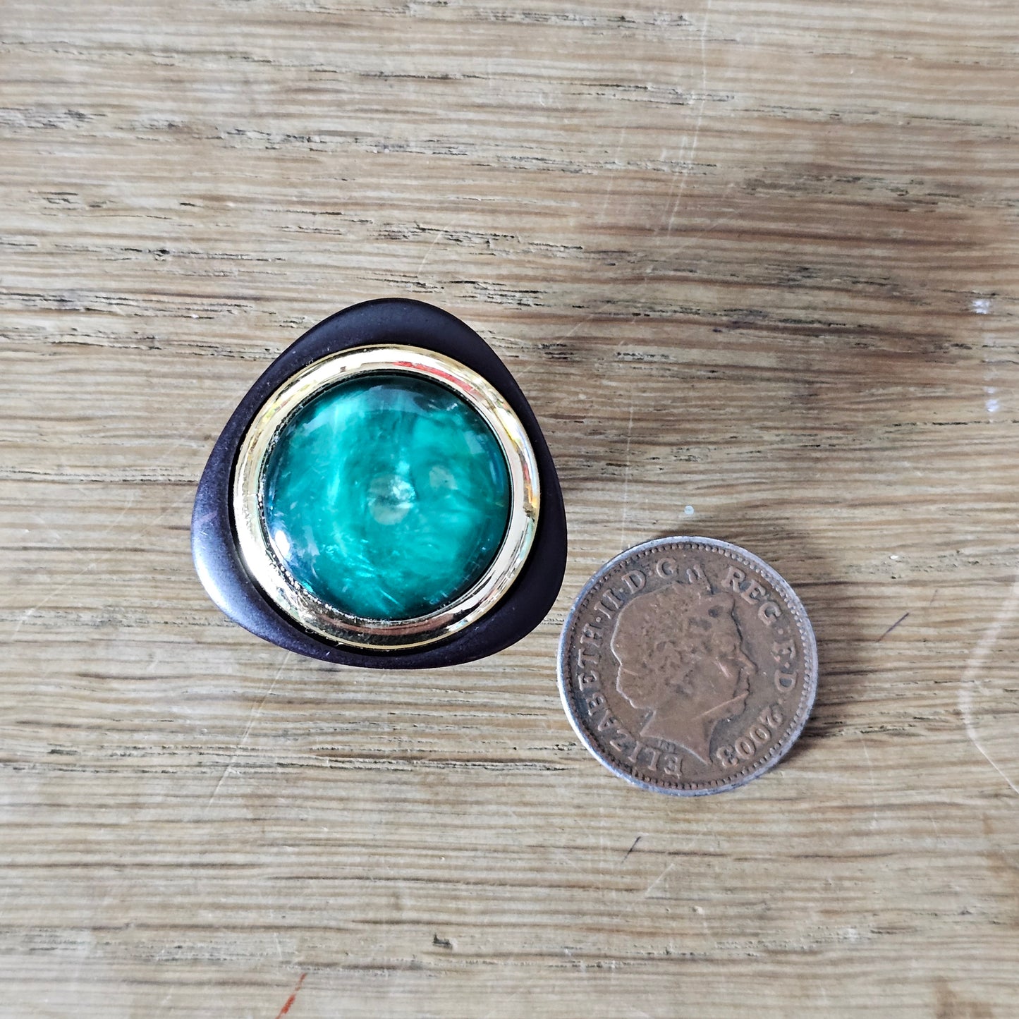 1980s black & gold-tone clip-on earrings with iridescent green cabochon centre