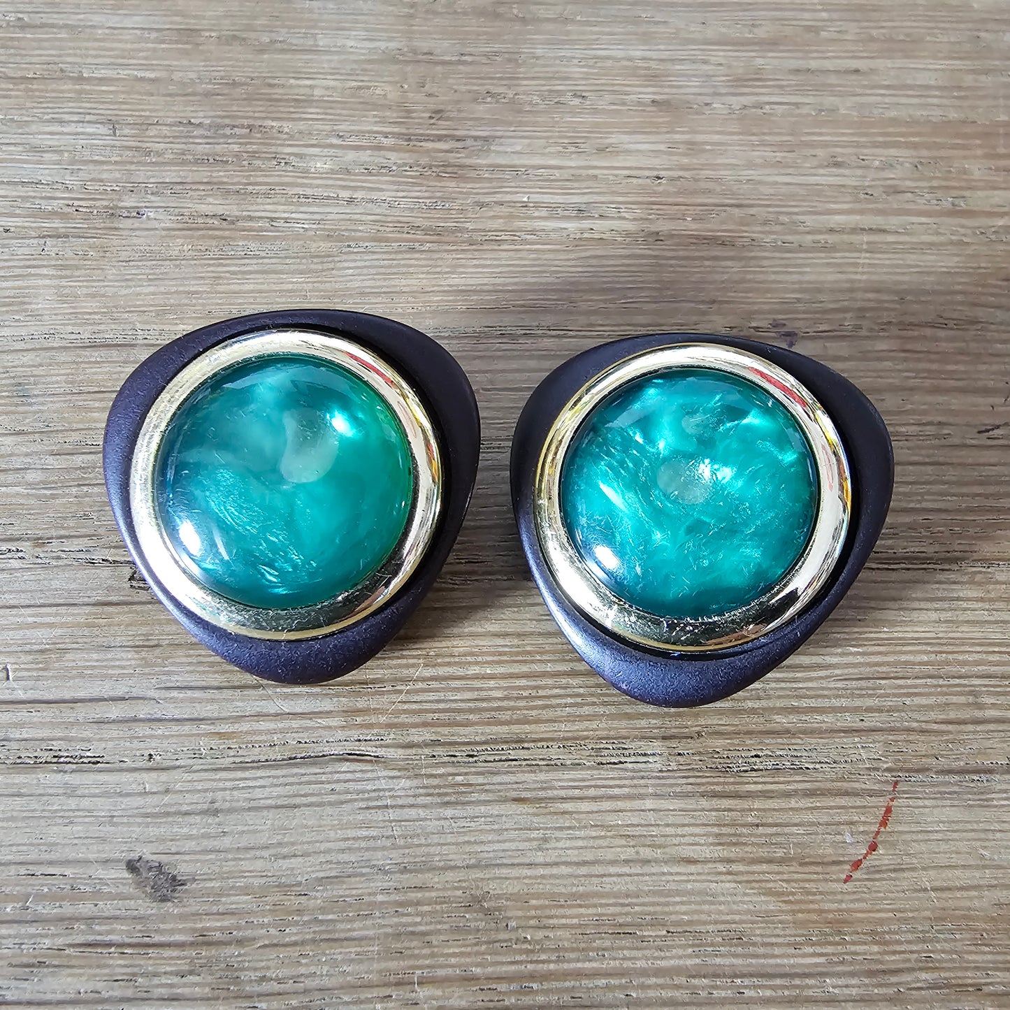 1980s black & gold-tone clip-on earrings with iridescent green cabochon centre