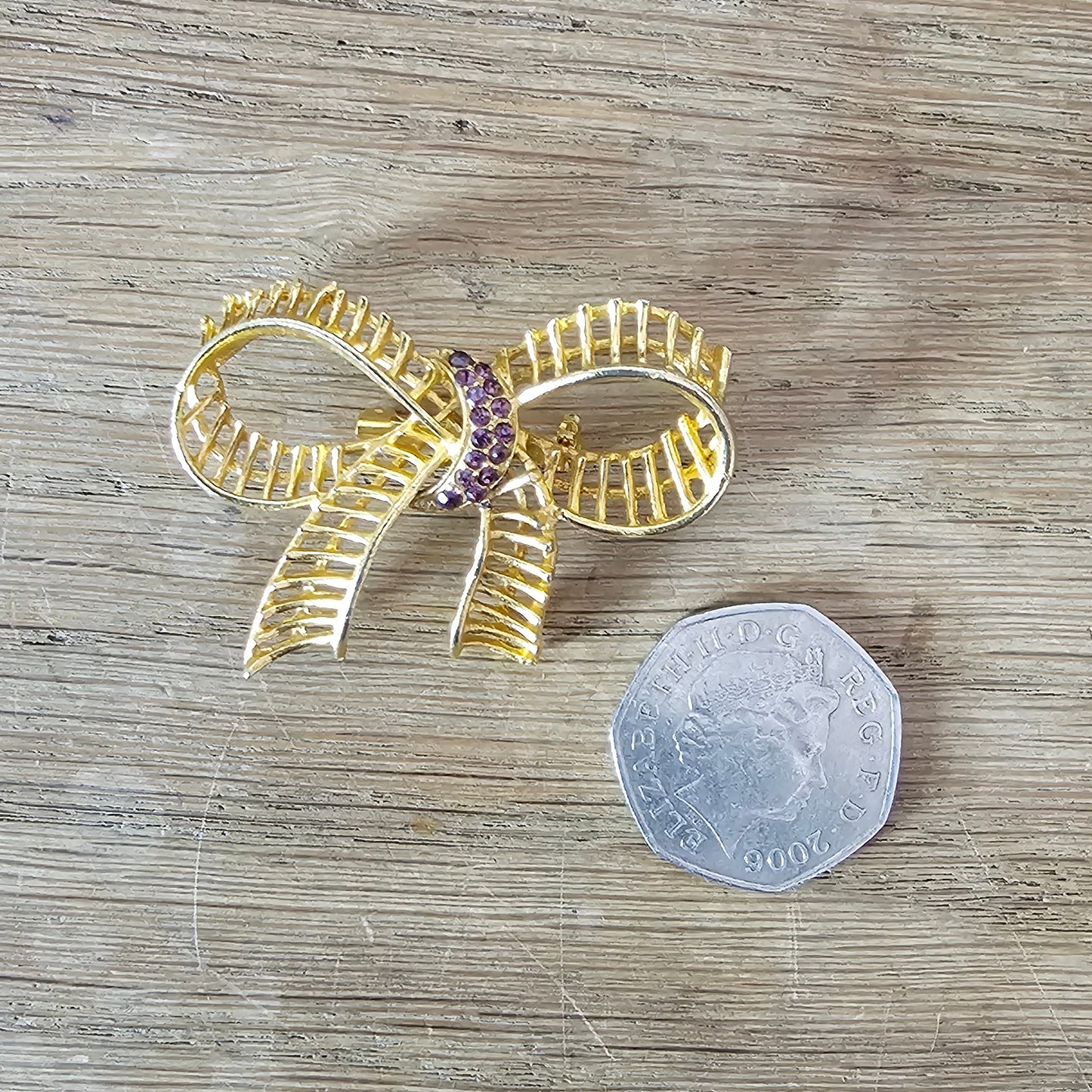 1960s purple rhinestone & gold-tone ribbon bow brooch