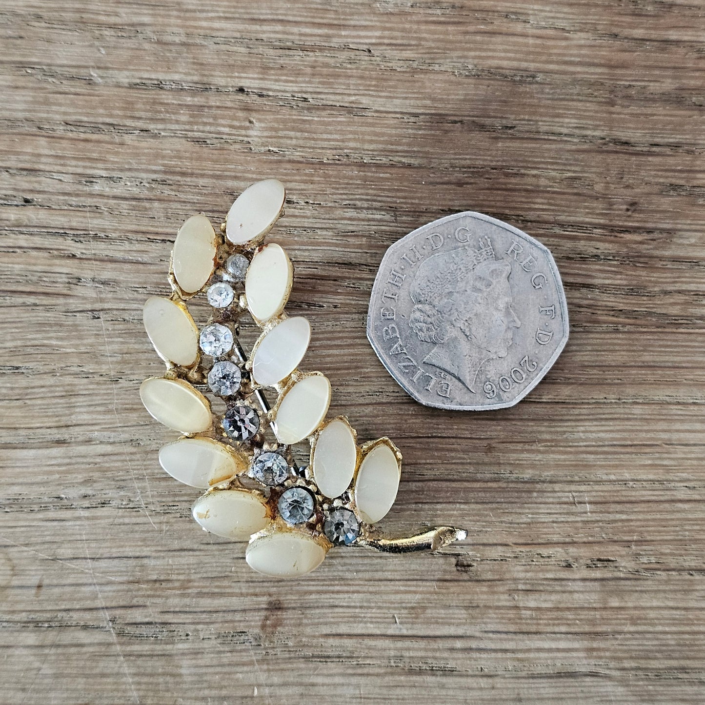 1950s gold-tone segmented leaf brooch with peach lucite leaves & diamanté spine