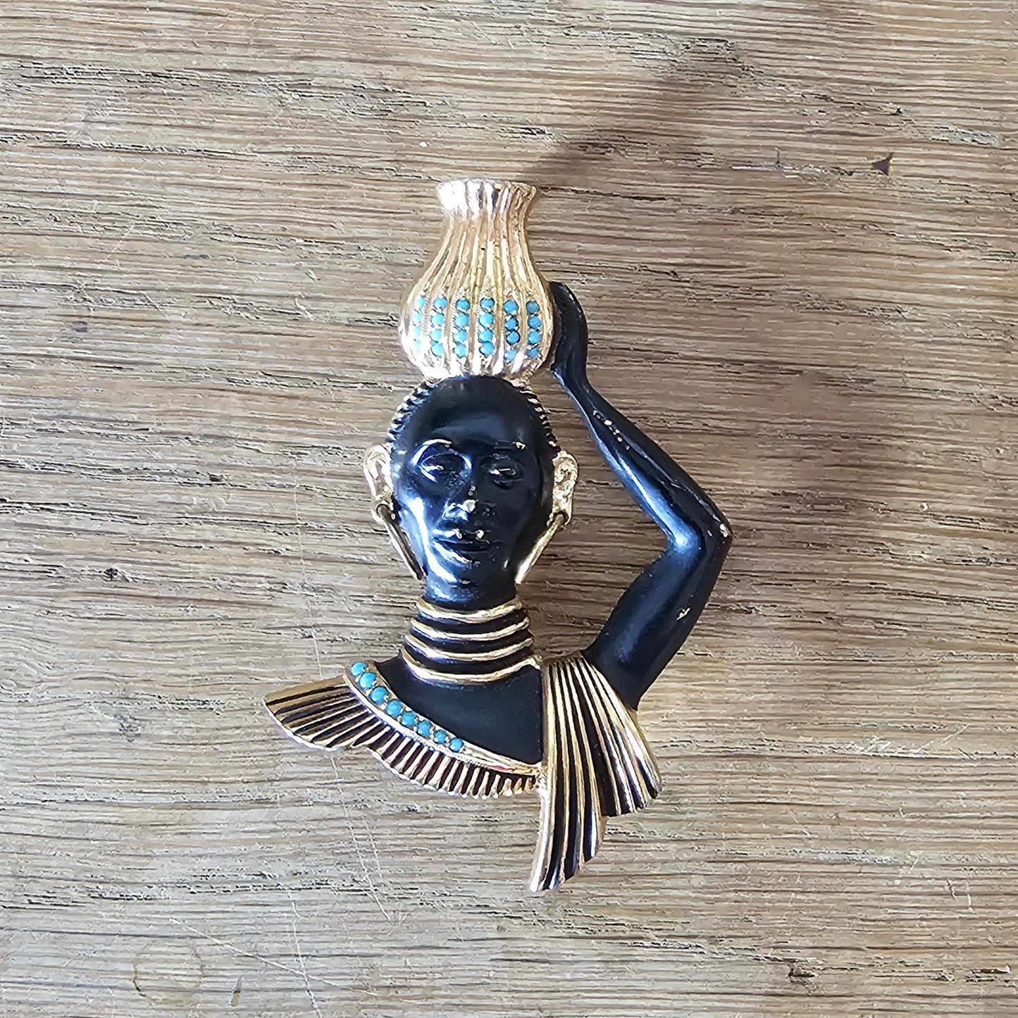 Mid-century gold-tone figural tribal bust brooch with turquoise seed bead accents