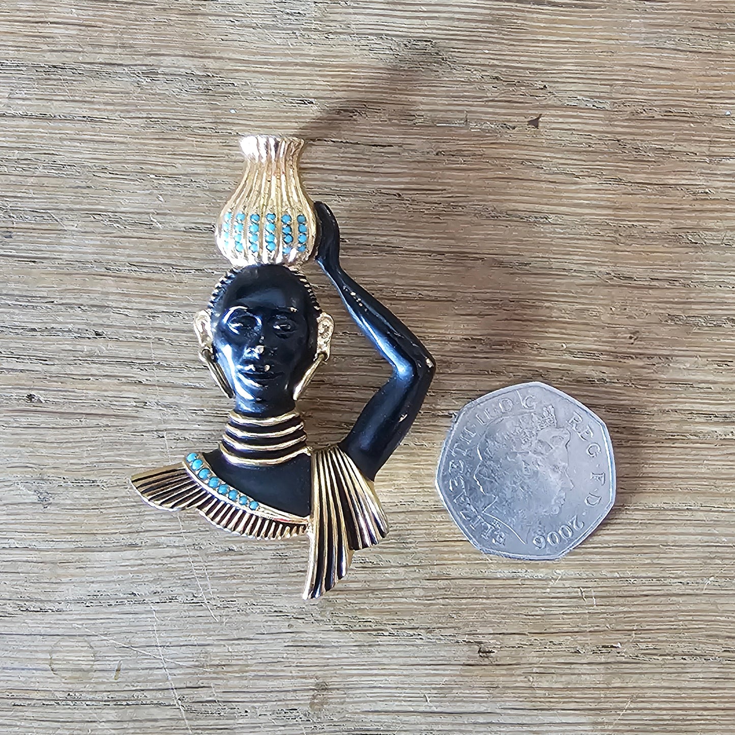 Mid-century gold-tone figural tribal bust brooch with turquoise seed bead accents